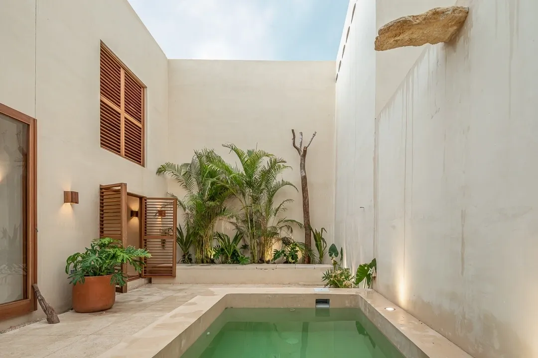 A pool in the middle of an indoor courtyard.