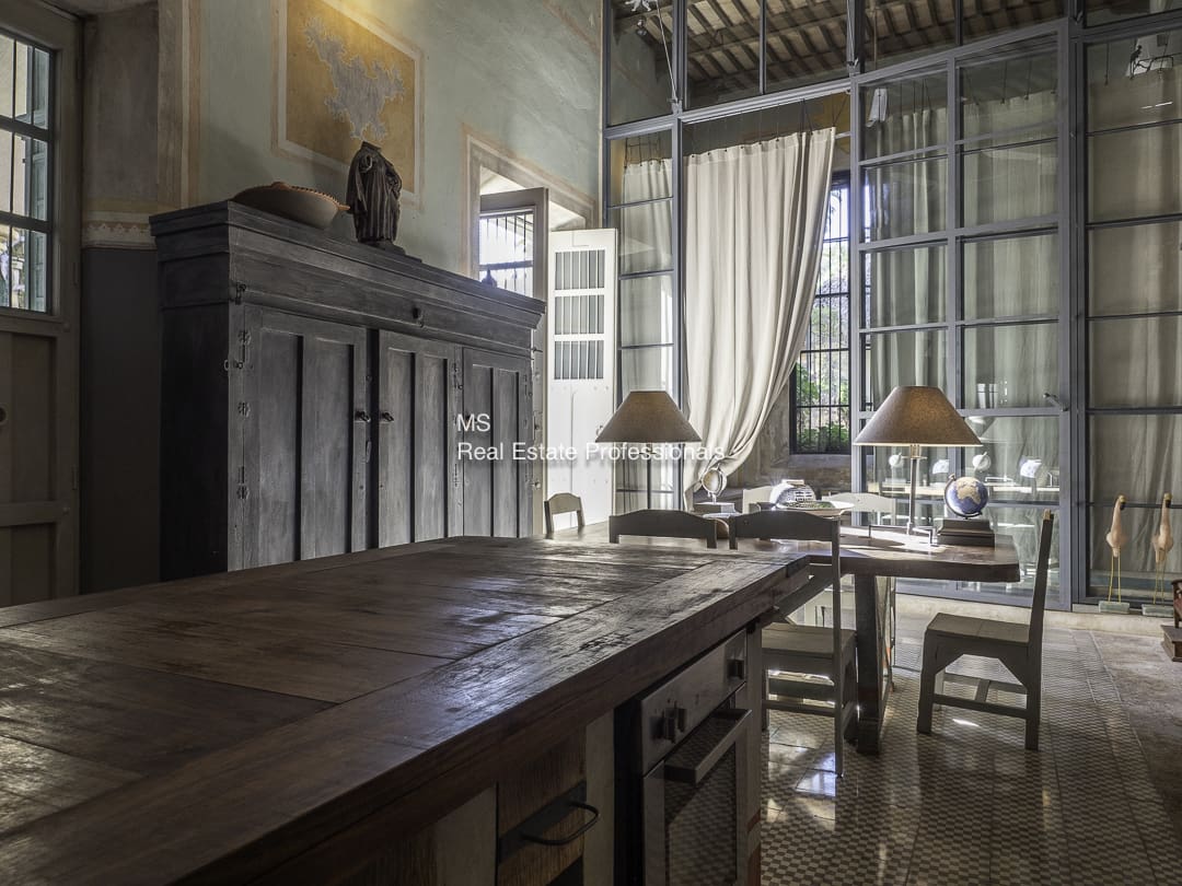 Rustic dining room with wooden furniture and natural light.