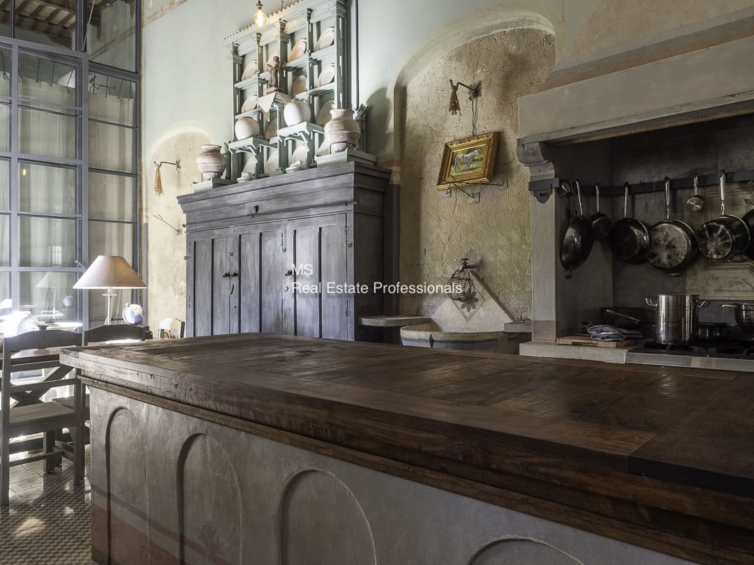 A vintage kitchen with wooden furniture and antique utensils.
