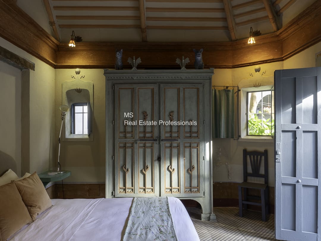 A cozy room with a large window and a decorative door.