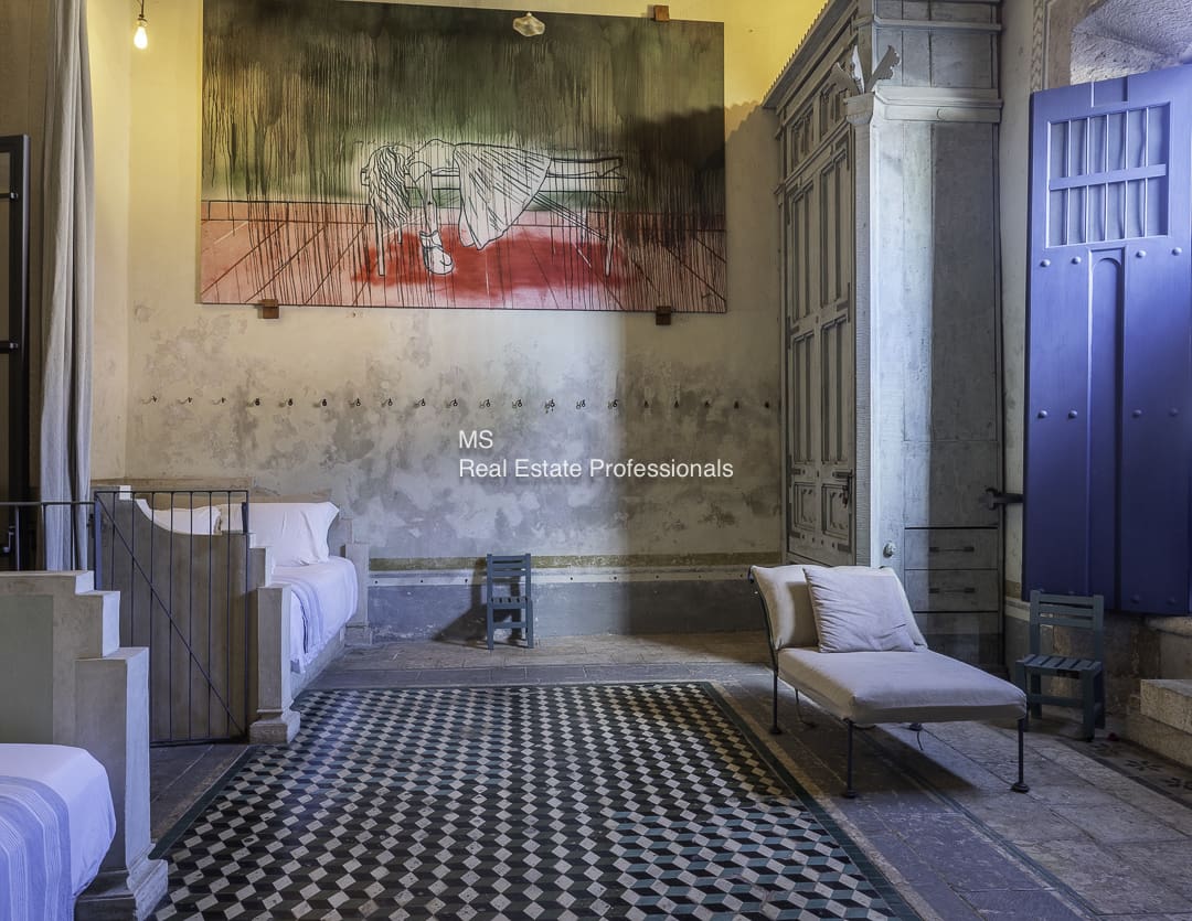Interior of a room with patterned floor tiles and a sofa.
