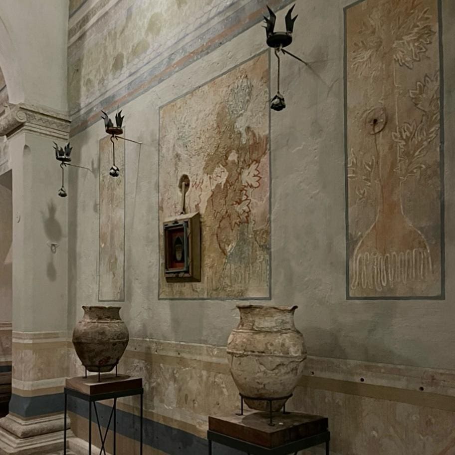 Ancient artifacts displayed in a rustic, weathered museum room.