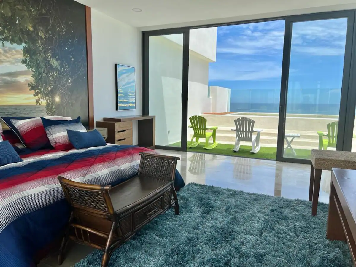 A modern living room with ocean view and glass doors.