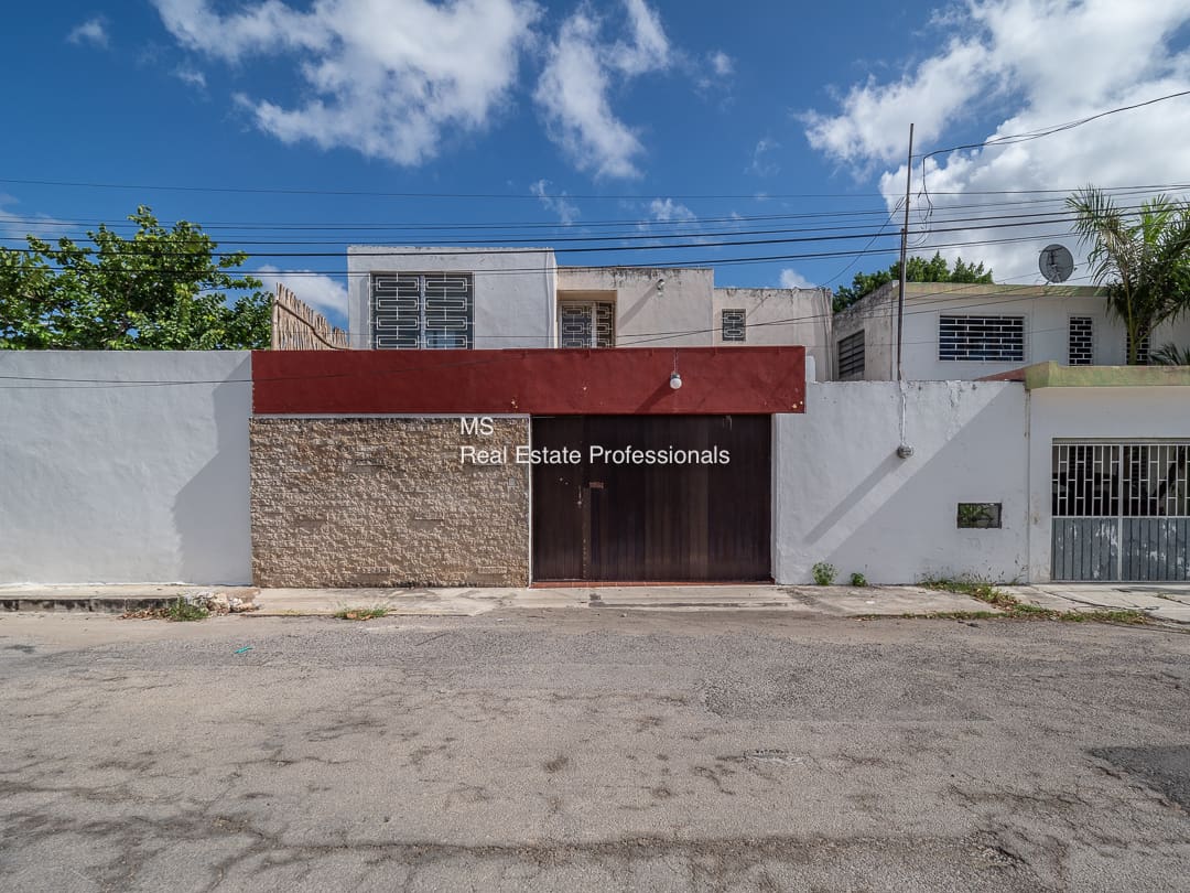 A building with a red door and white walls.