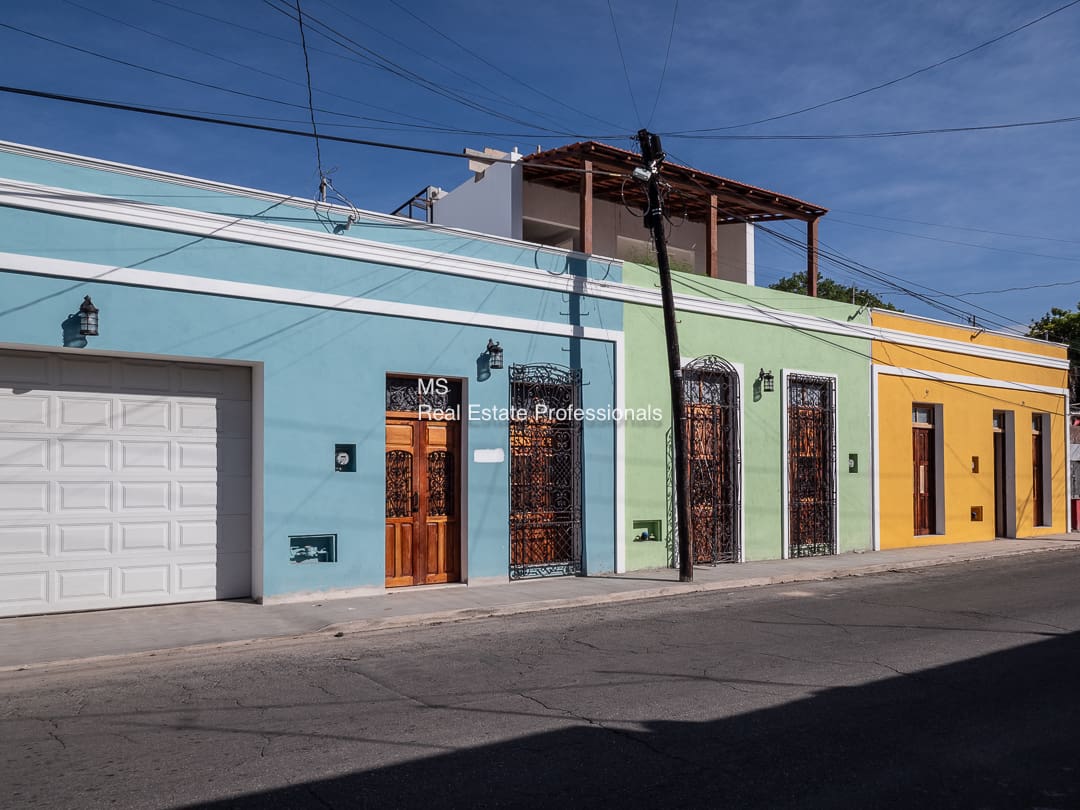 A row of colorful buildings on the side of a street.