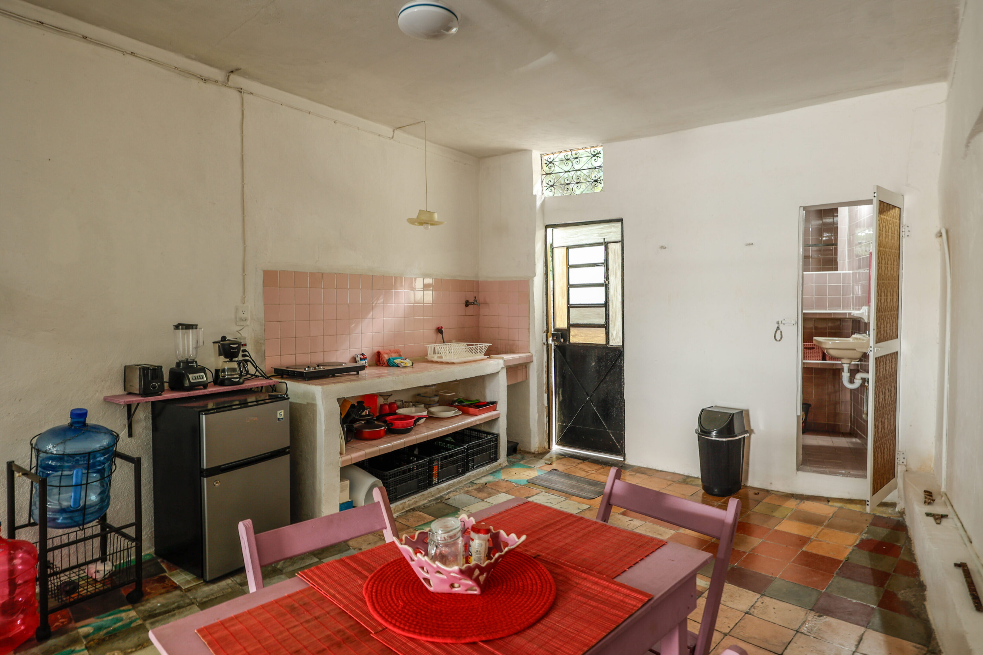 A kitchen with a table and chairs in it