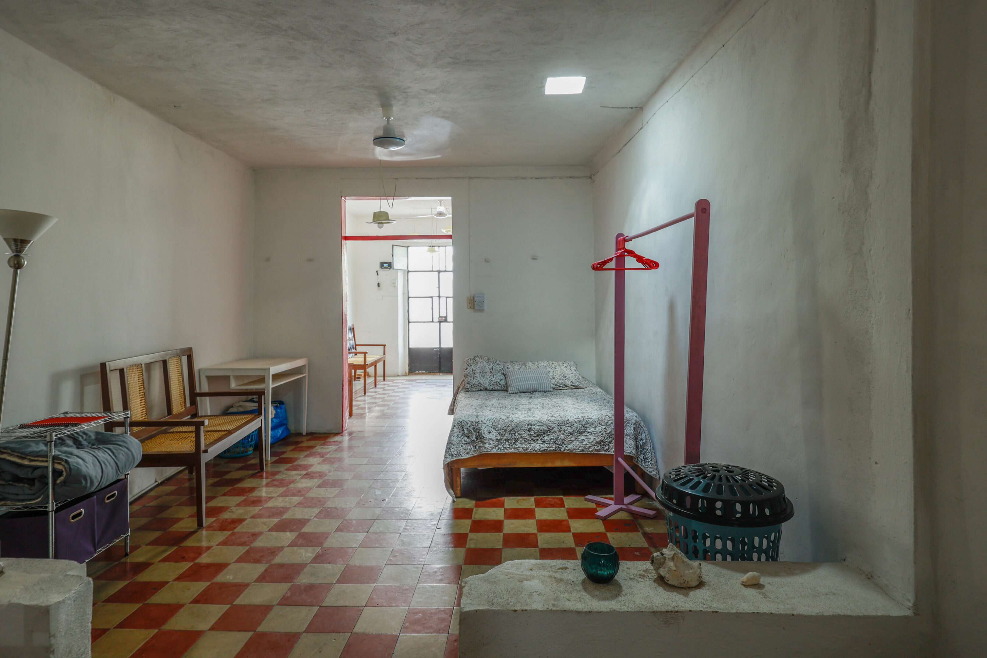 A room with a bed, chair and table.