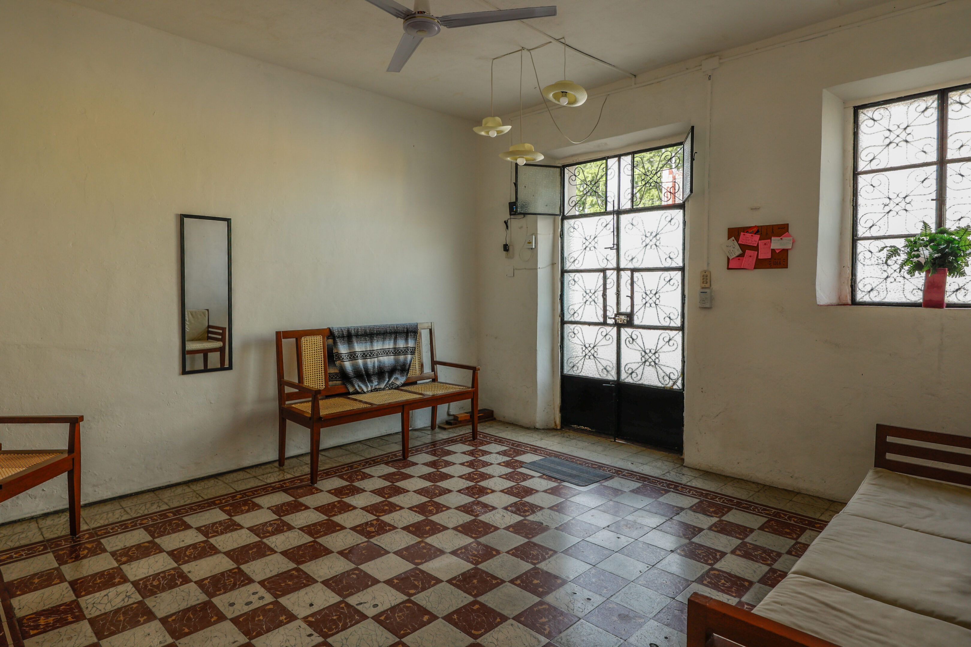 A room with checkered floor and a bench