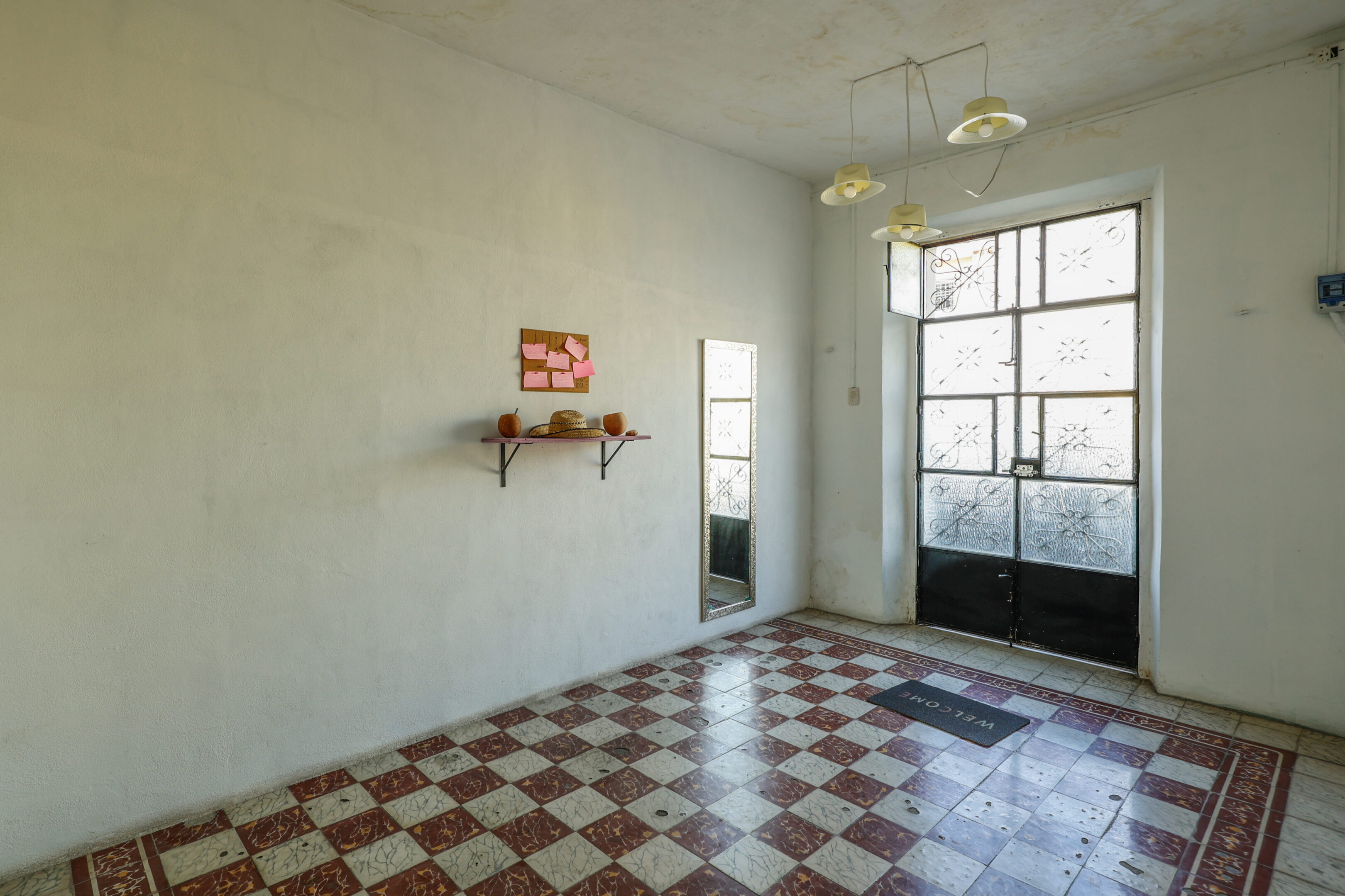 A room with a checkered floor and a window.