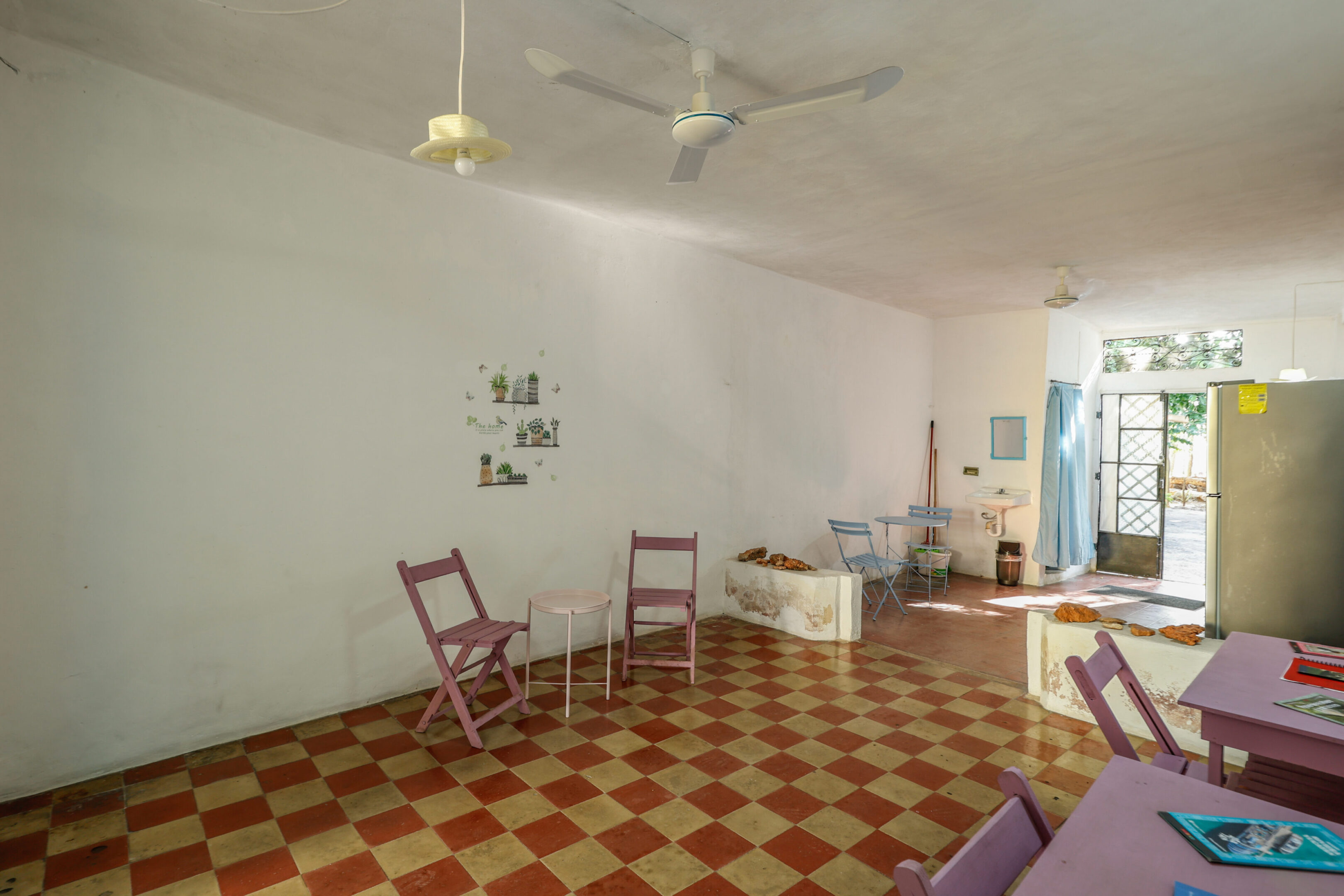 A room with three chairs and two tables.