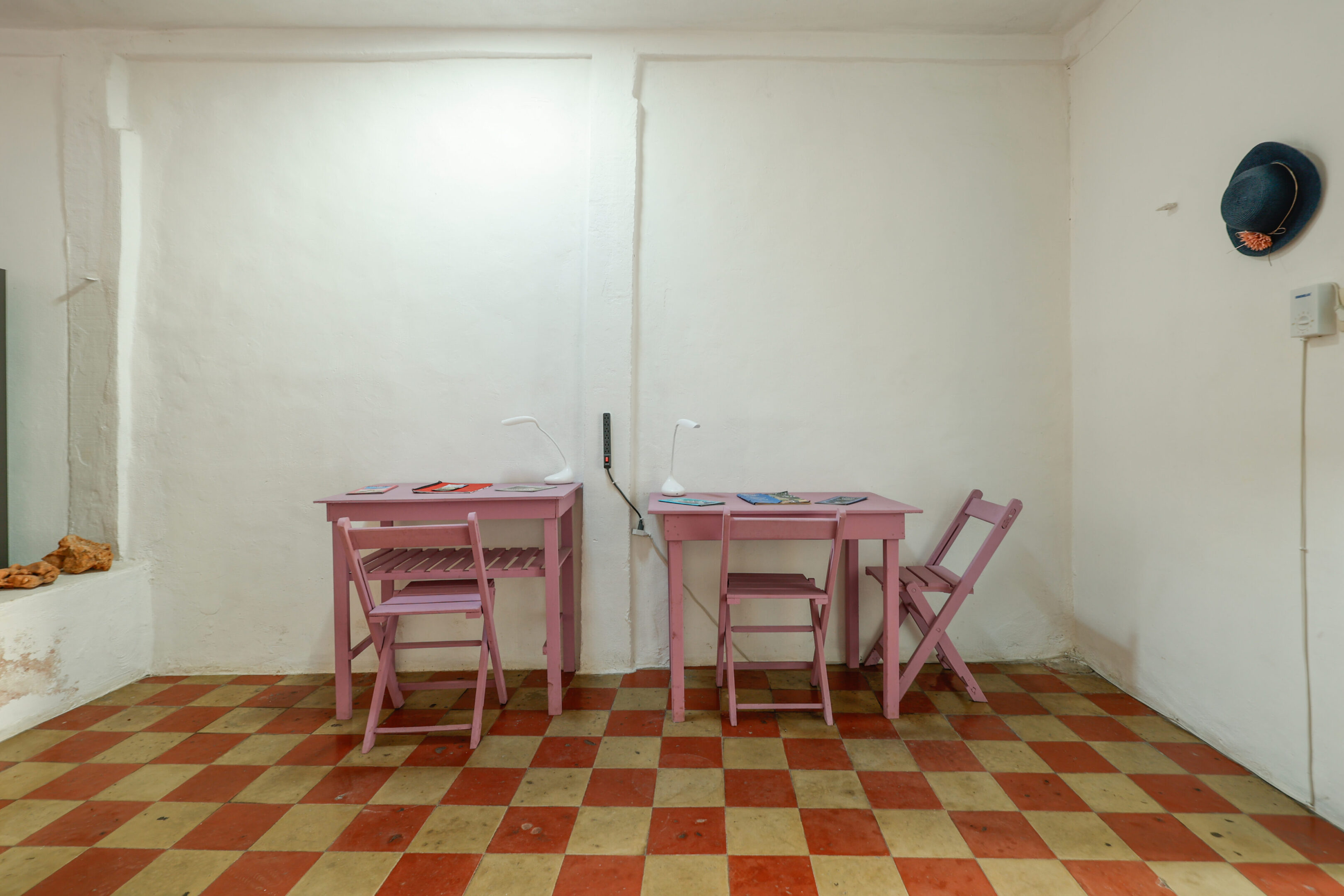Two pink chairs and a table in a room.