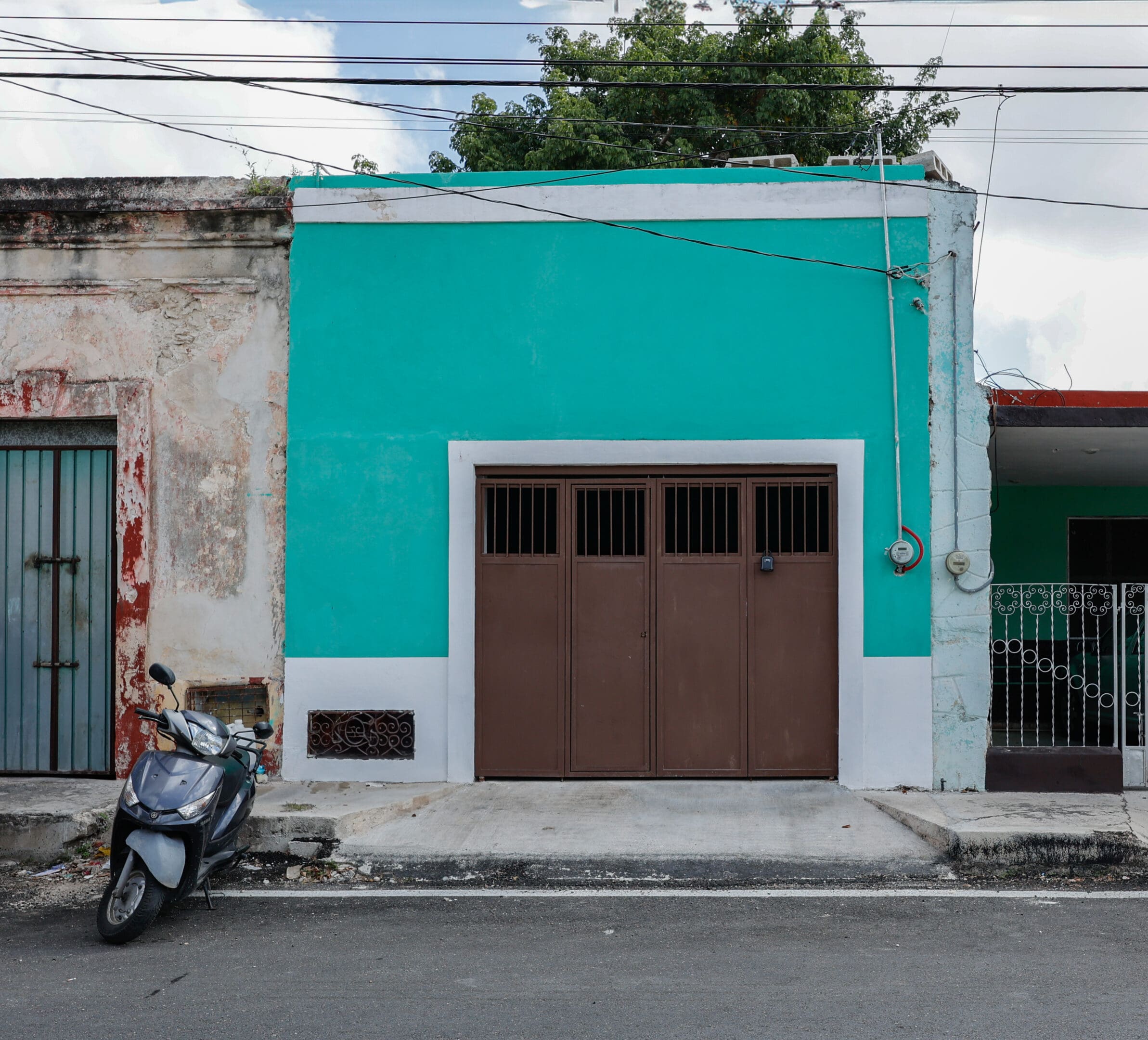 A motorcycle parked in front of a garage.