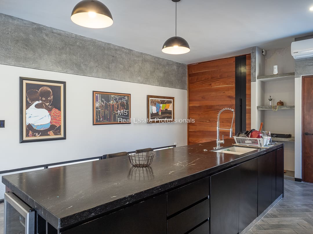 A kitchen with a sink and a counter