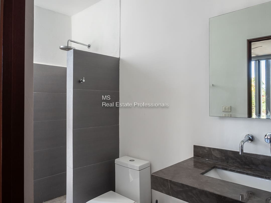 A bathroom with a sink, toilet and shower.