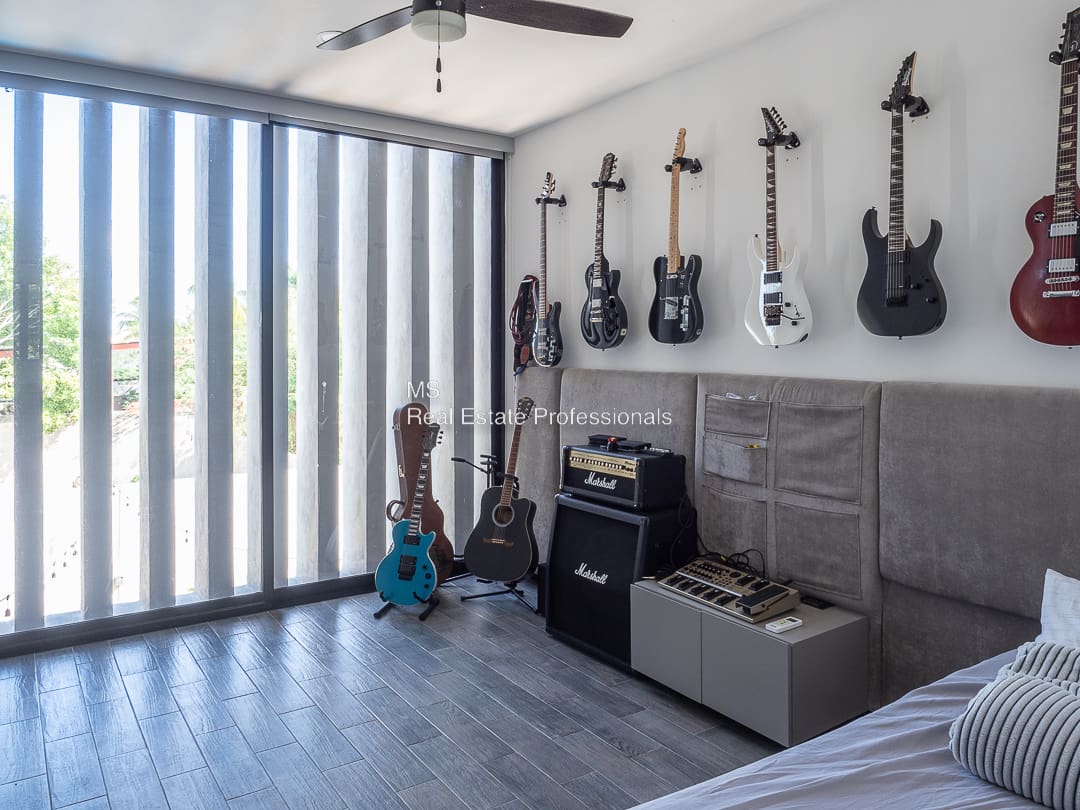 A room with guitars hanging on the wall.
