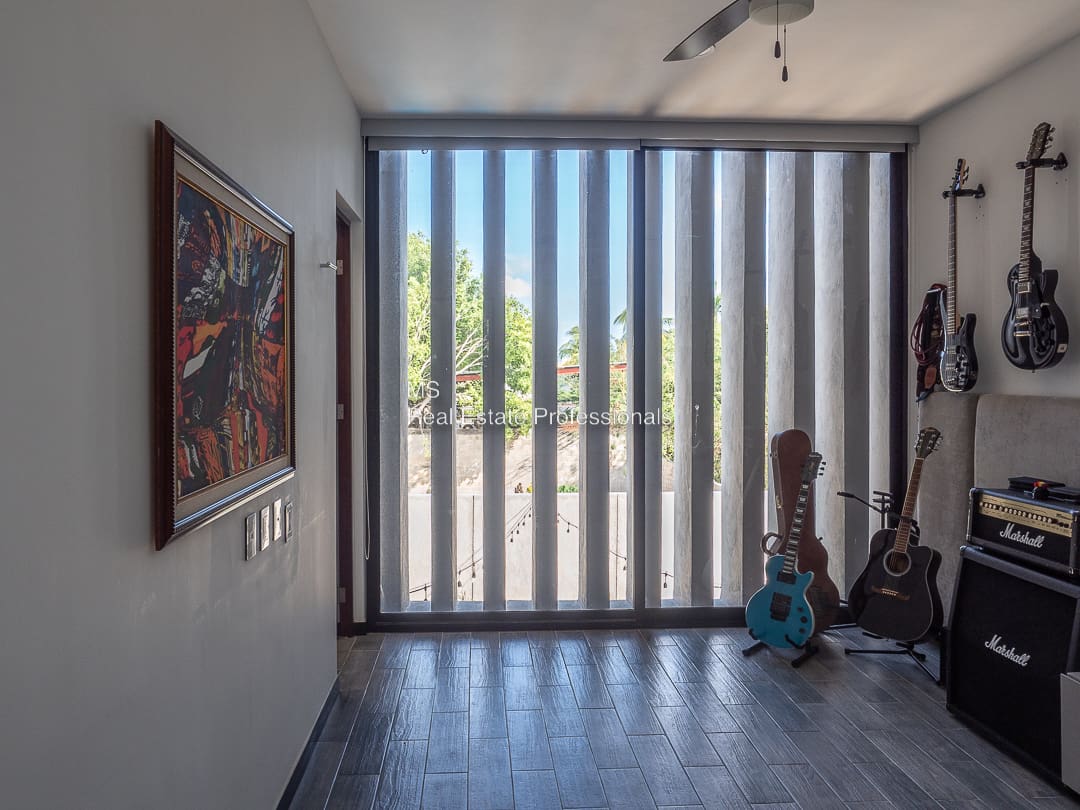 A room with a guitar and a picture on the wall
