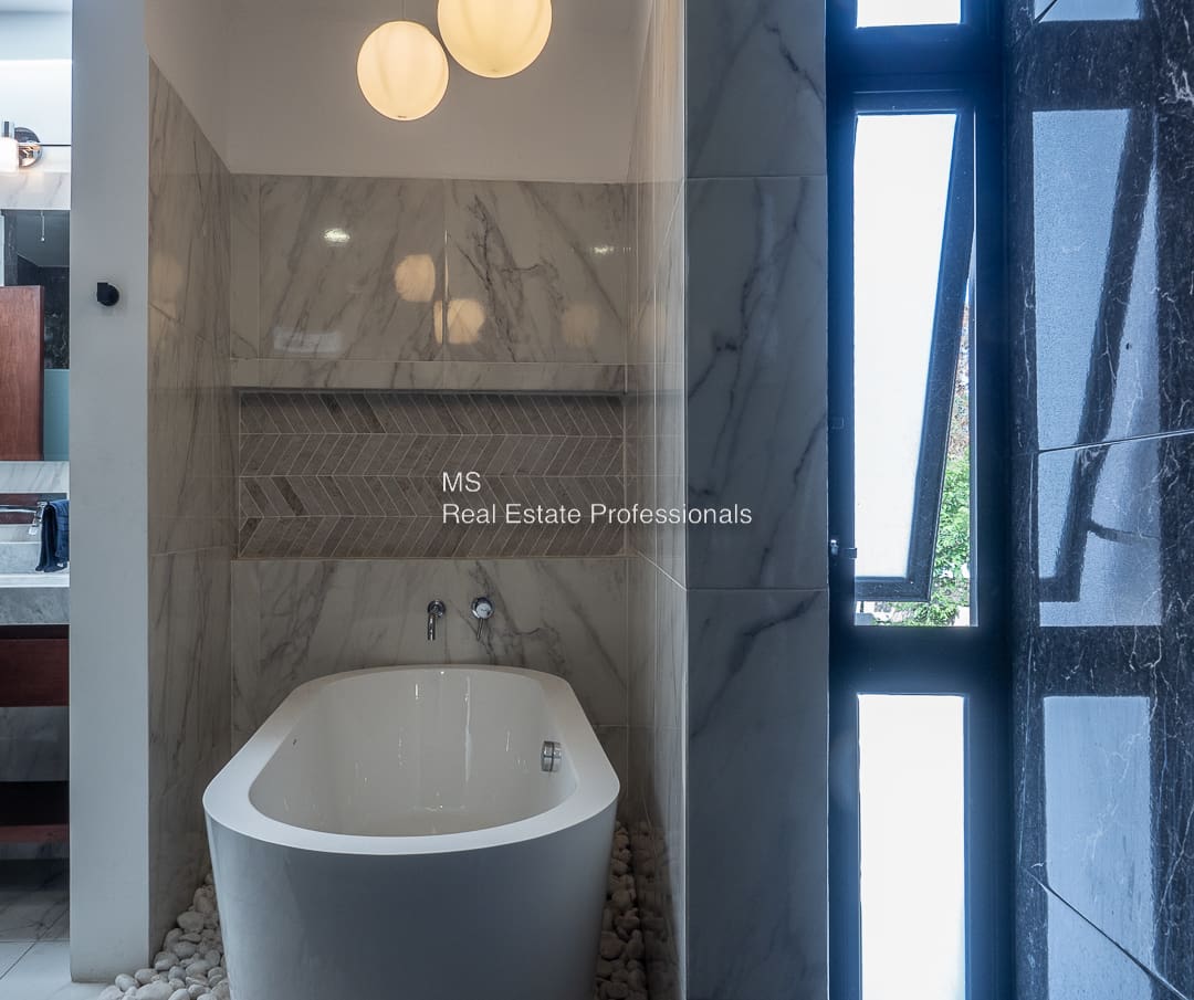 A bathroom with a tub and window in it