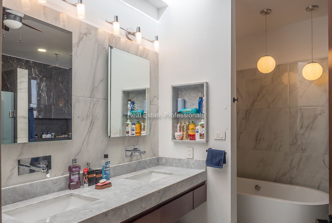 A bathroom with two sinks and a mirror.