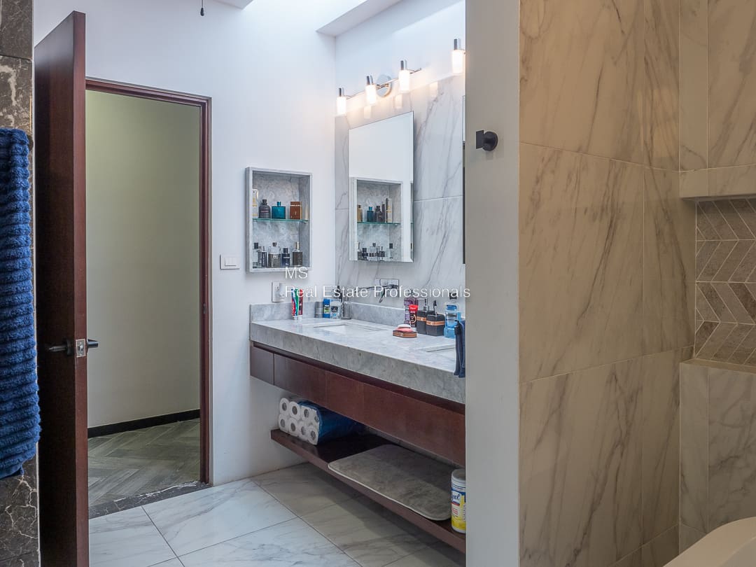 A bathroom with two sinks and mirrors in it