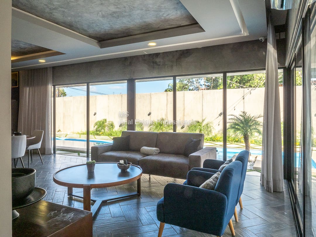 A living room with couches and chairs in it