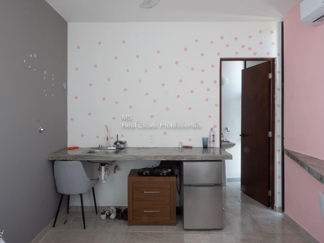 A room with a desk and chair in it
