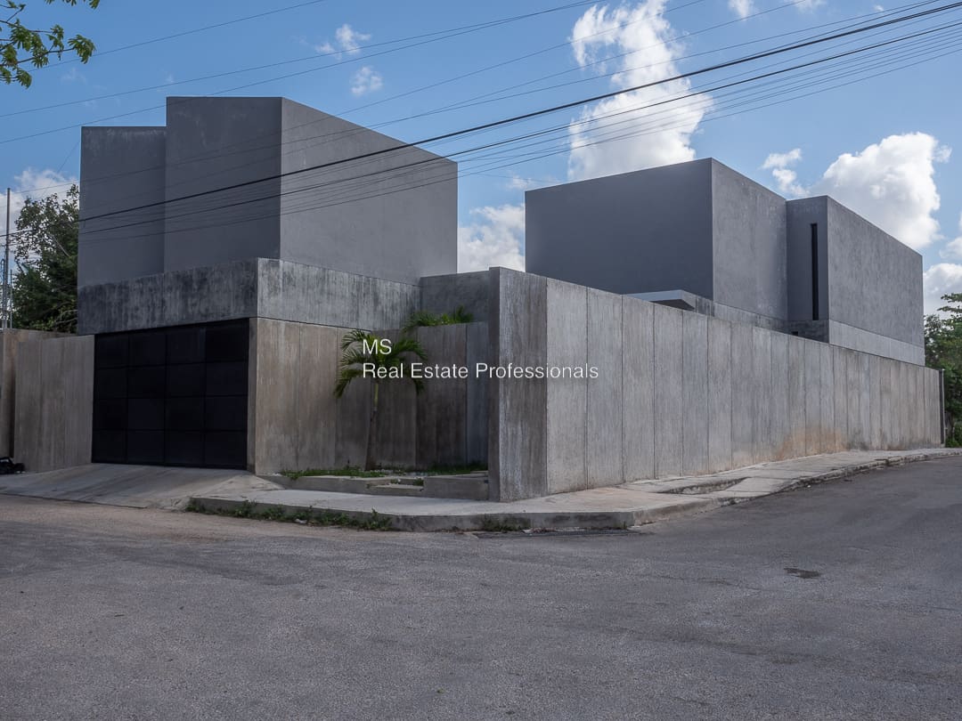 A building with concrete walls and a fence.