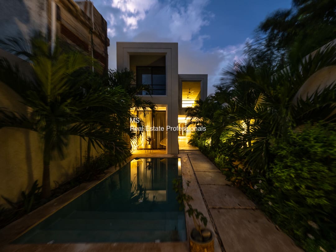 Modern house with pool at night.