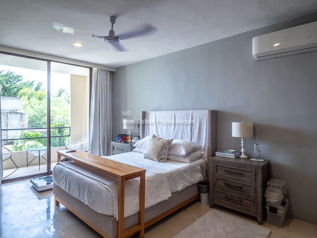 Bedroom with balcony and king-size bed.