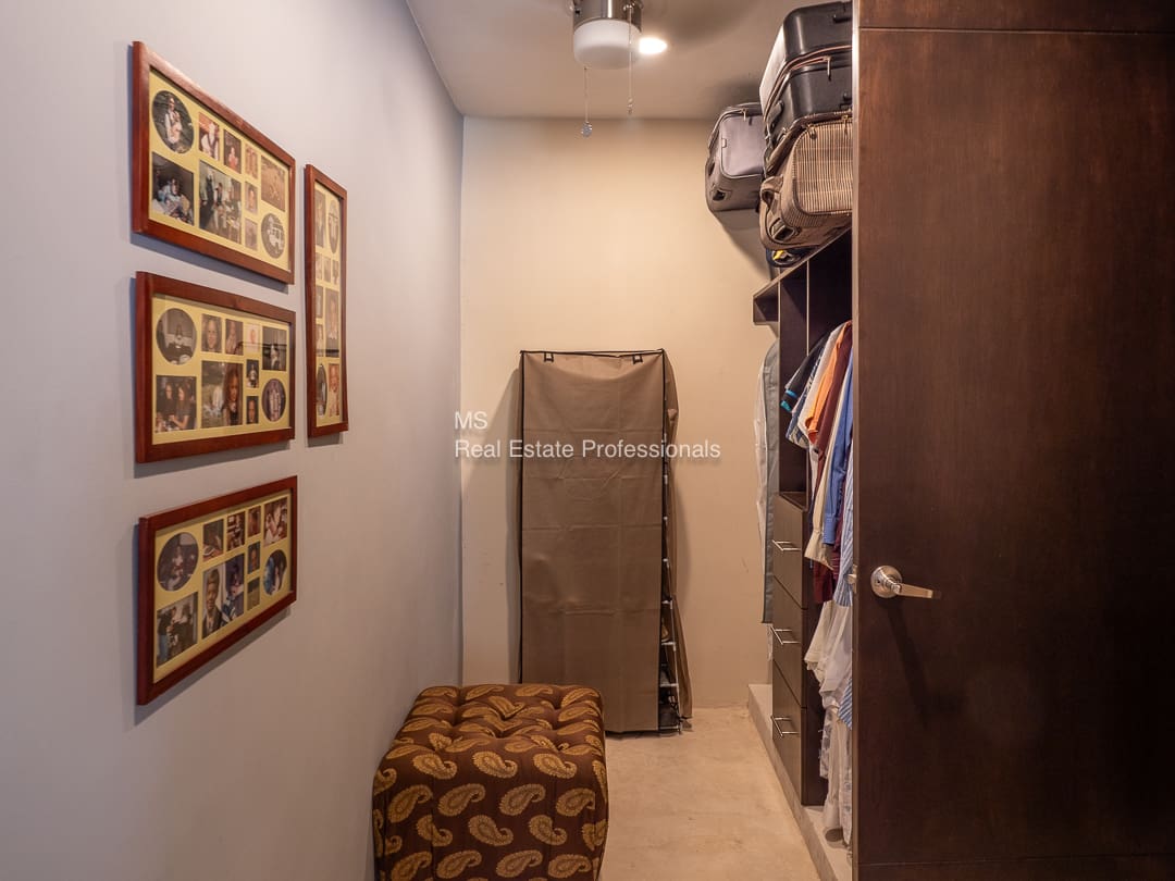 Spacious closet with family photos.