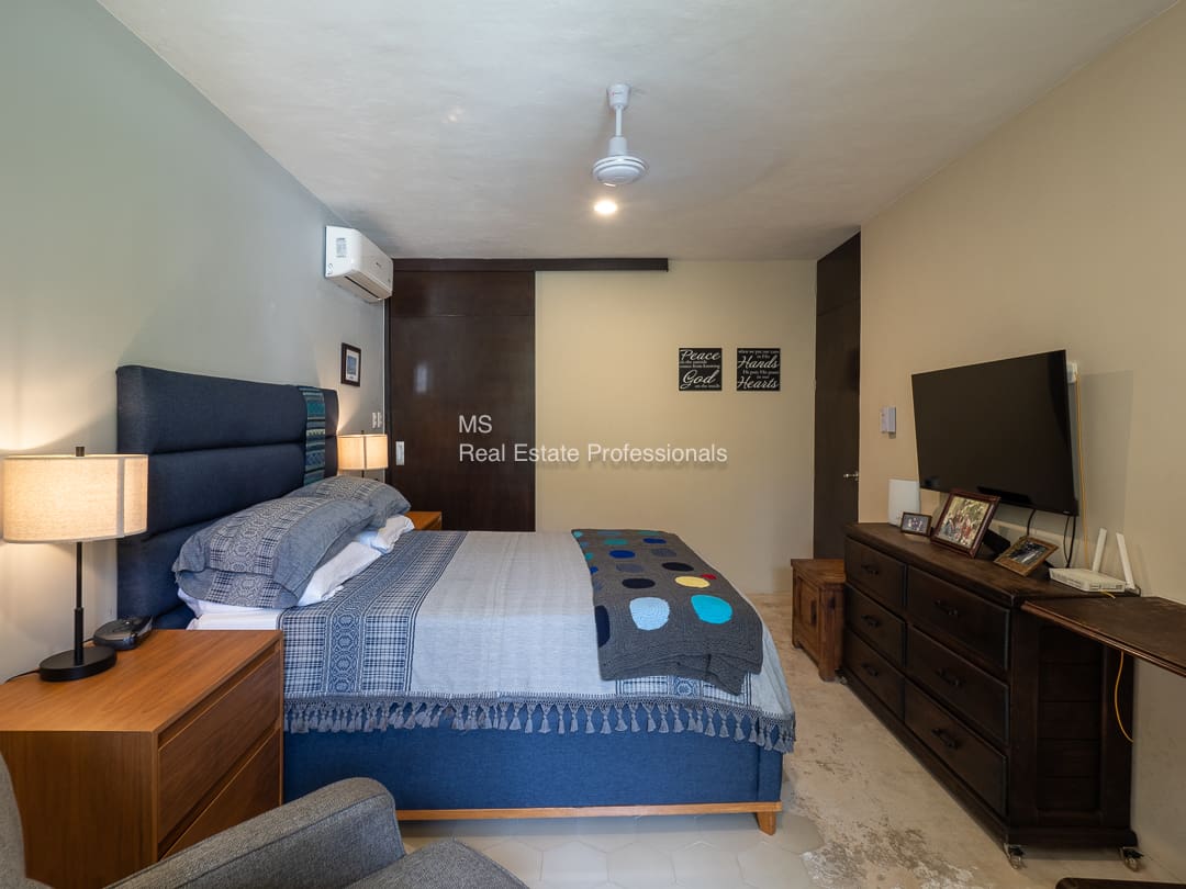 Bedroom with king-size bed and TV.