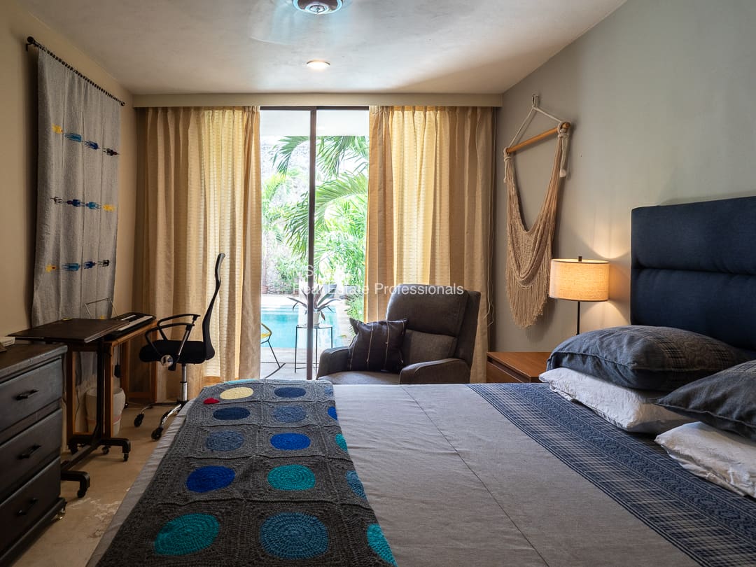 Bedroom with pool view and hammock.
