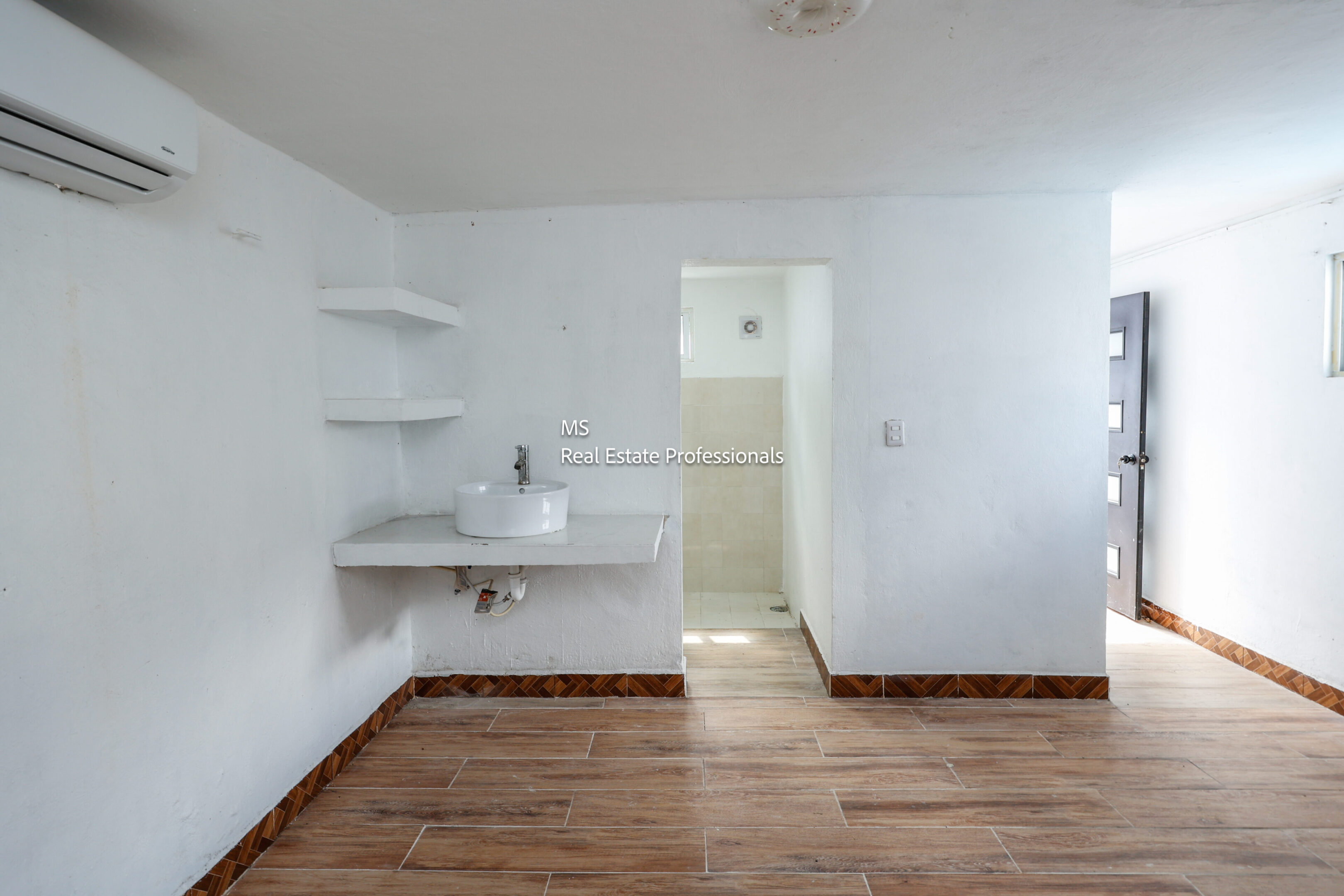 Empty room with sink and bathroom.