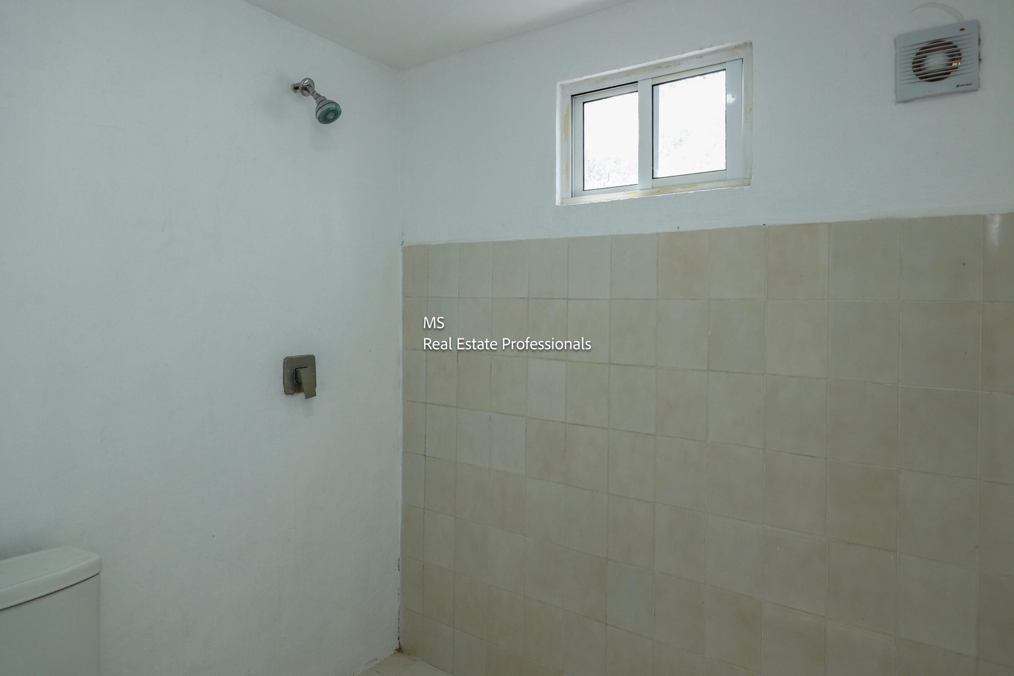 Simple bathroom with shower and window.