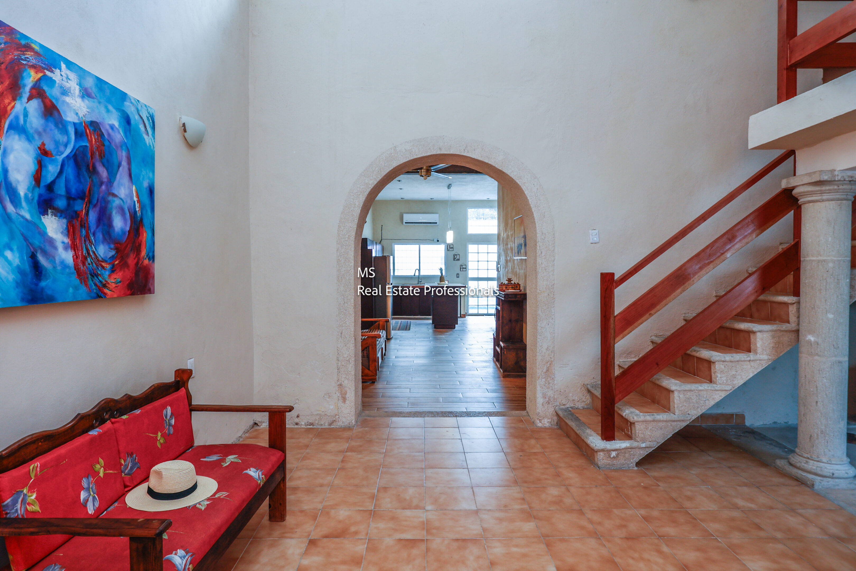 Home entryway with art and stairs.
