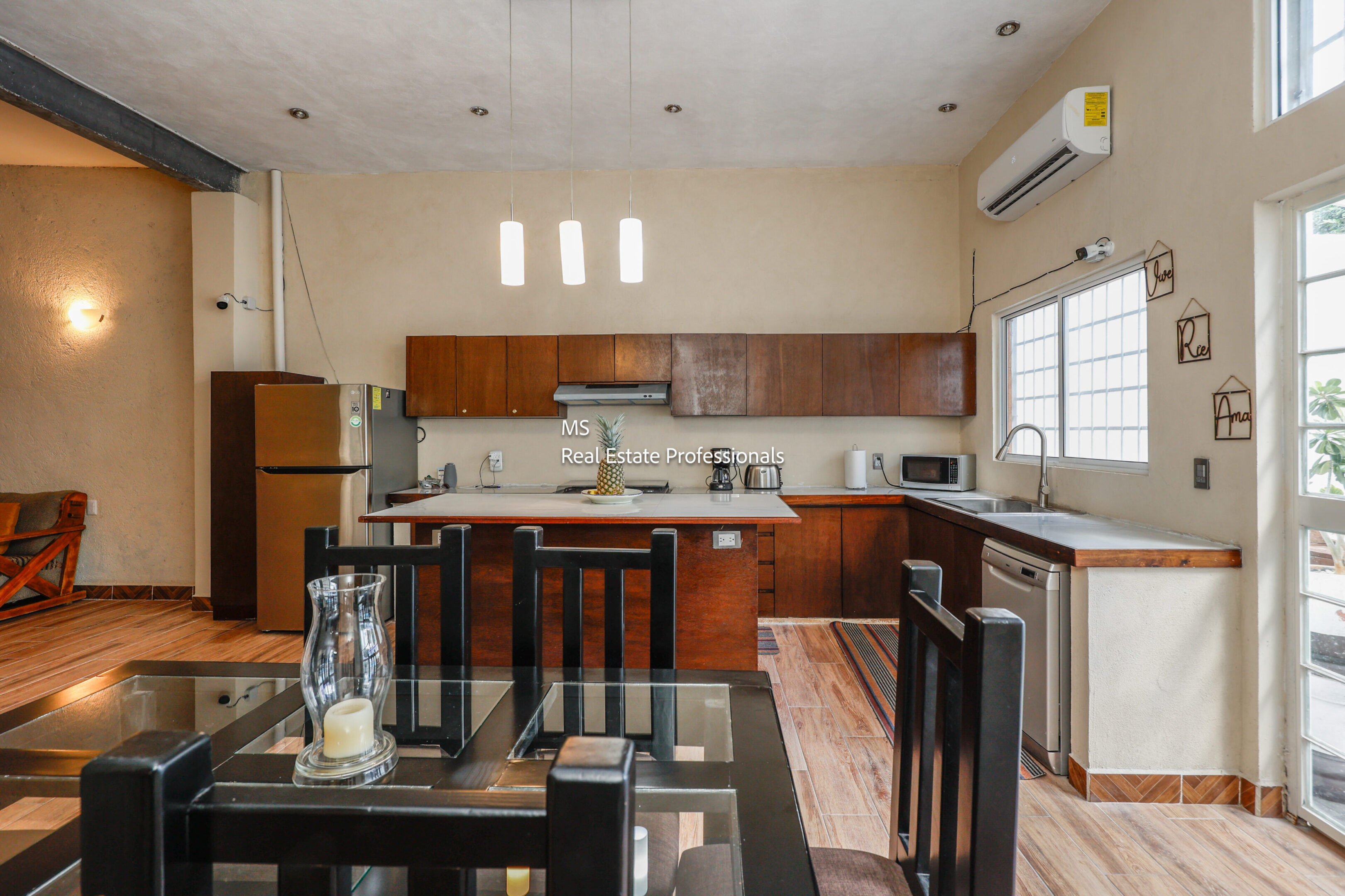 Modern kitchen with island and dining area.