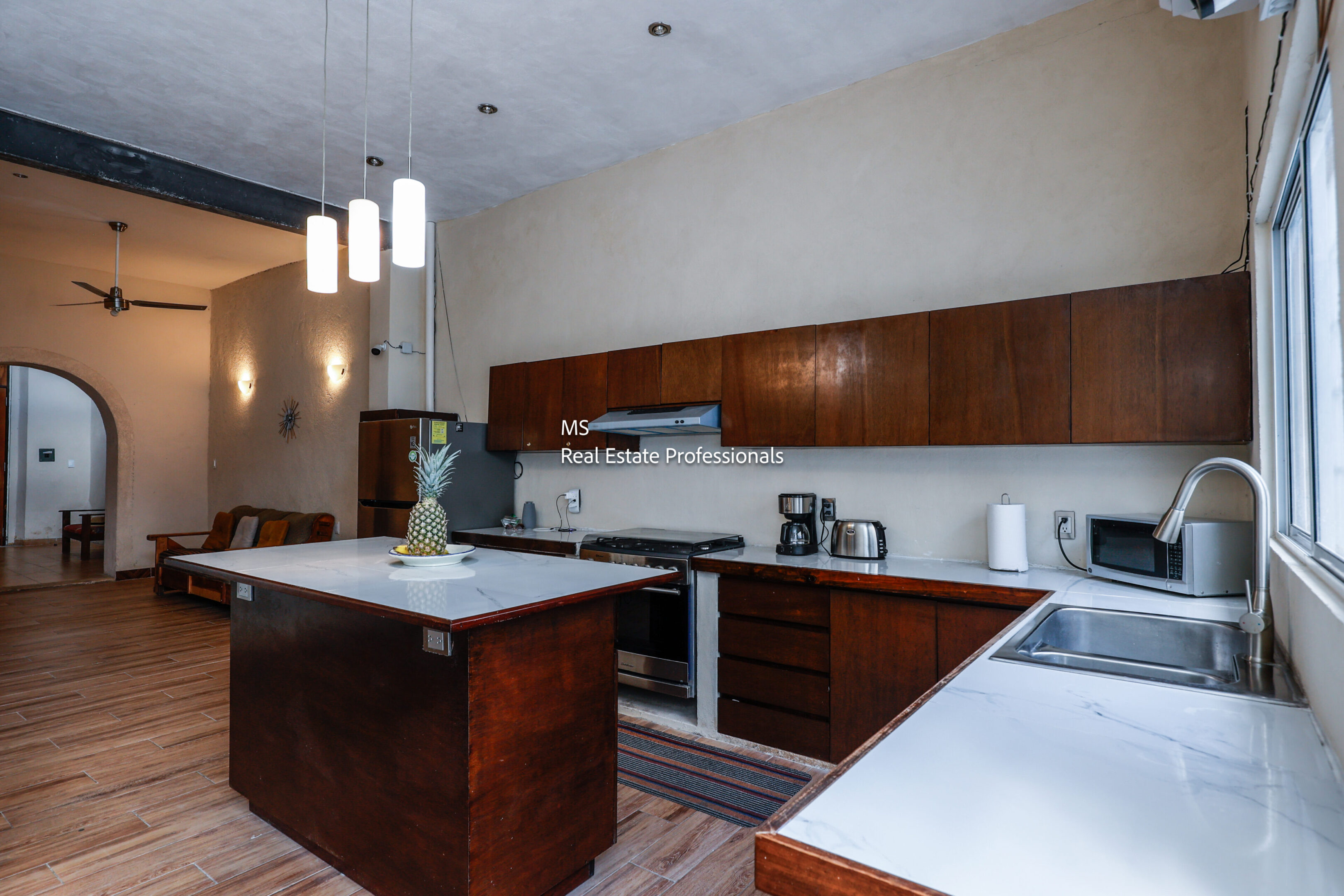Modern kitchen with island and wood cabinets.