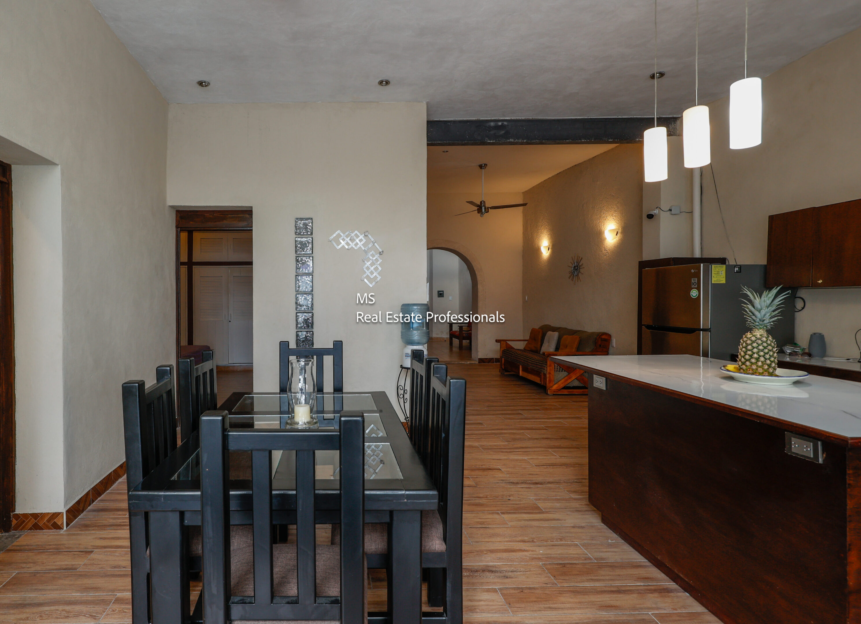 Modern dining area with kitchen view.