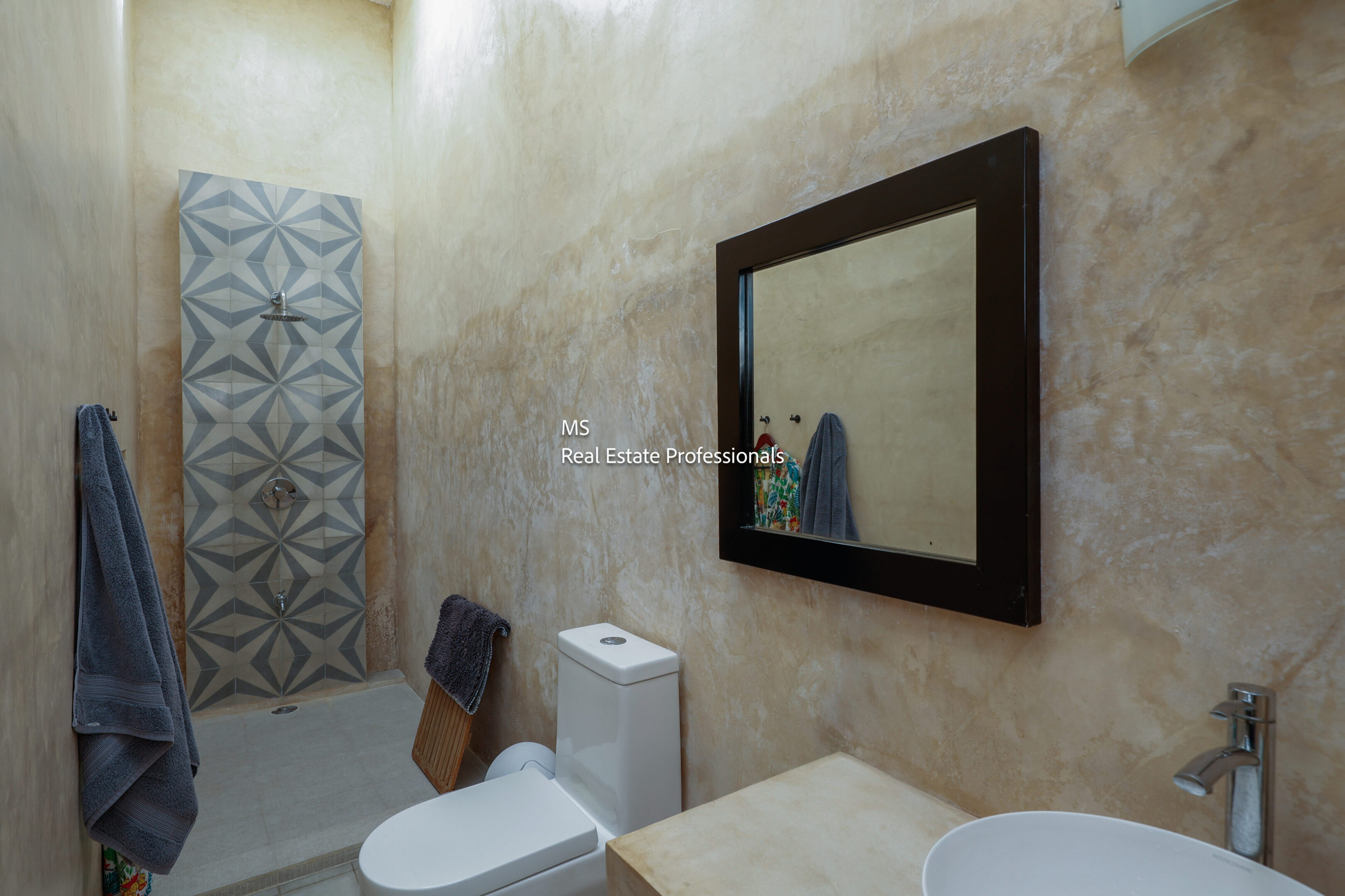 Modern bathroom with geometric tile shower.