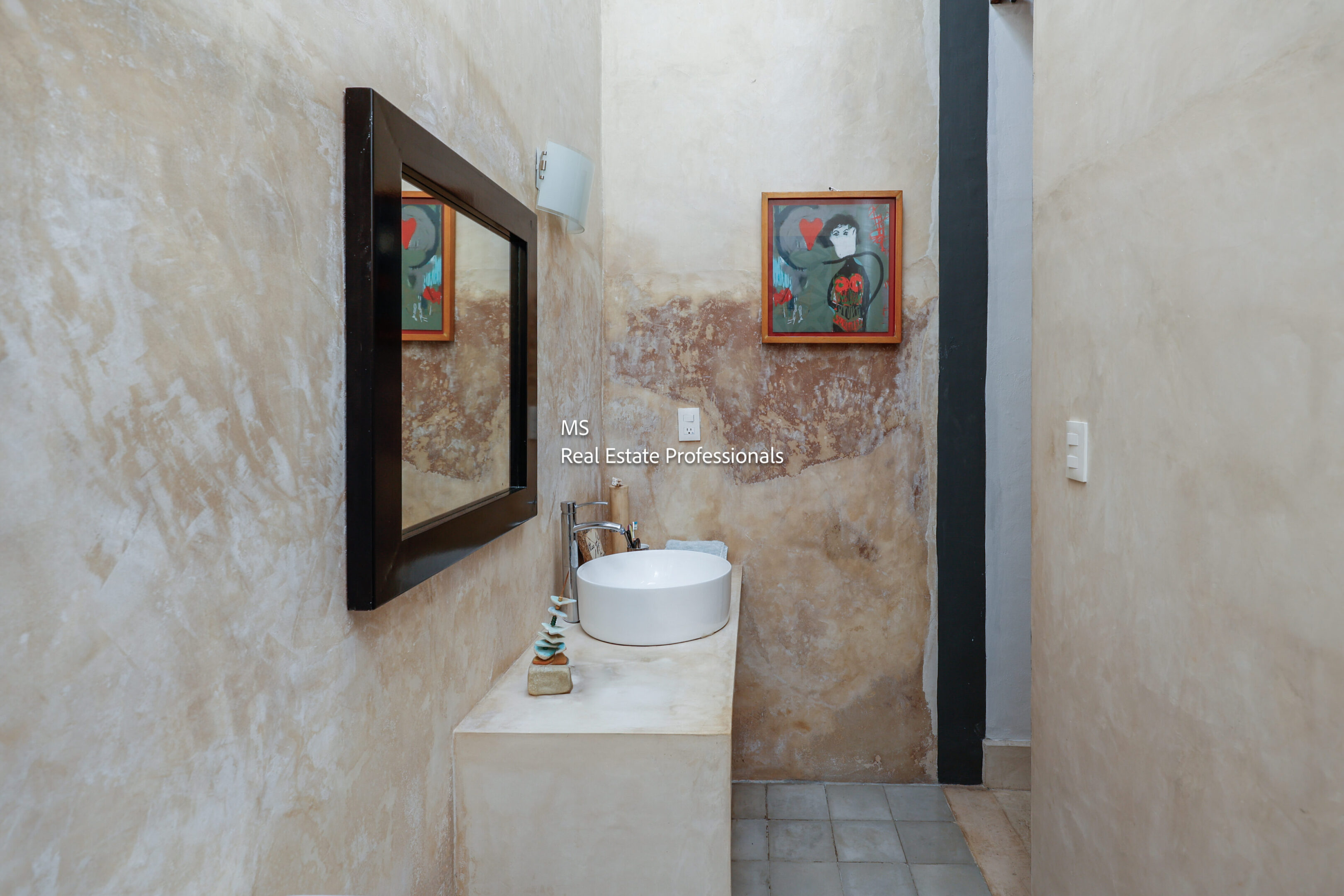 Stylish bathroom with sink and artwork.
