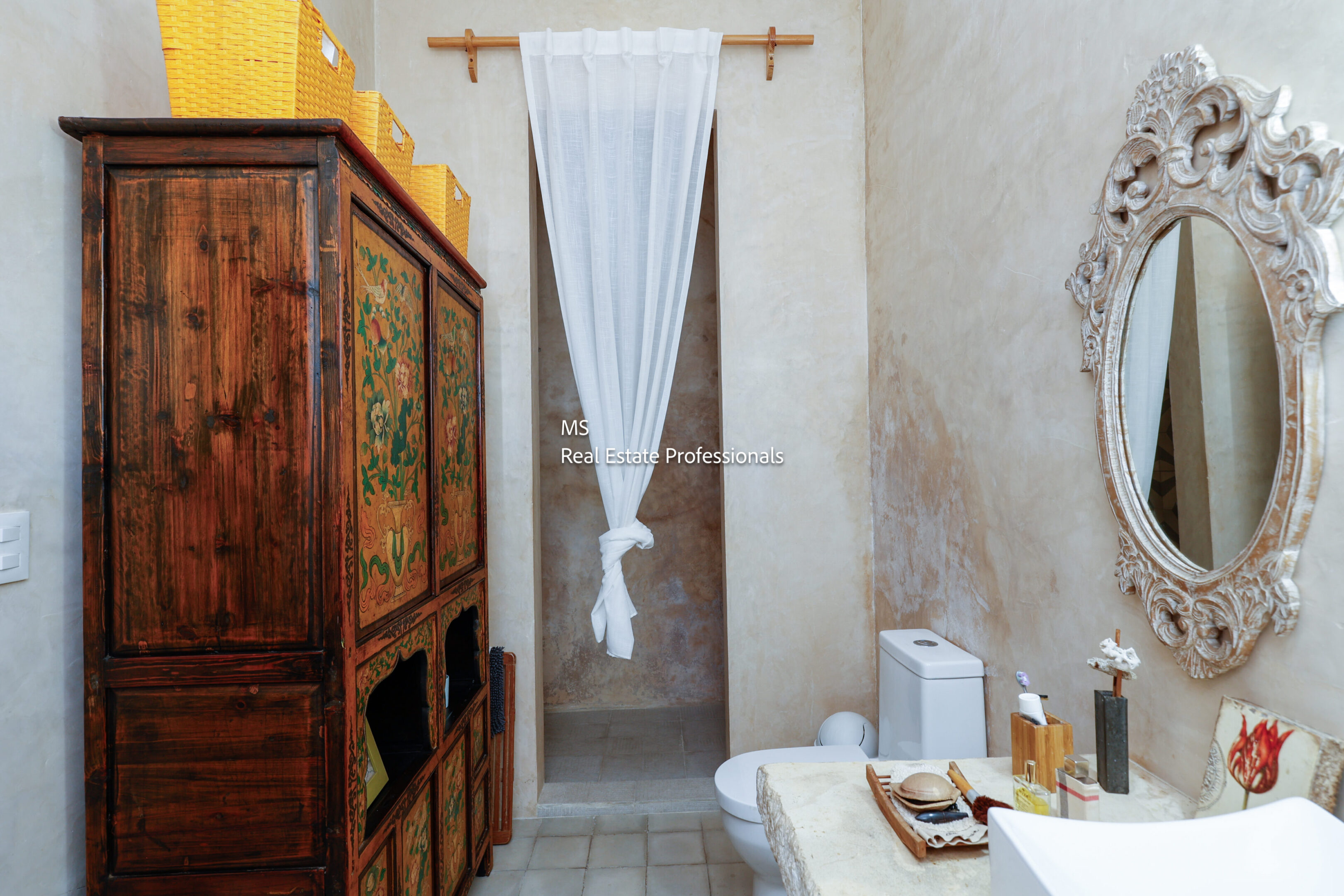 Rustic bathroom with antique cabinet and mirror.