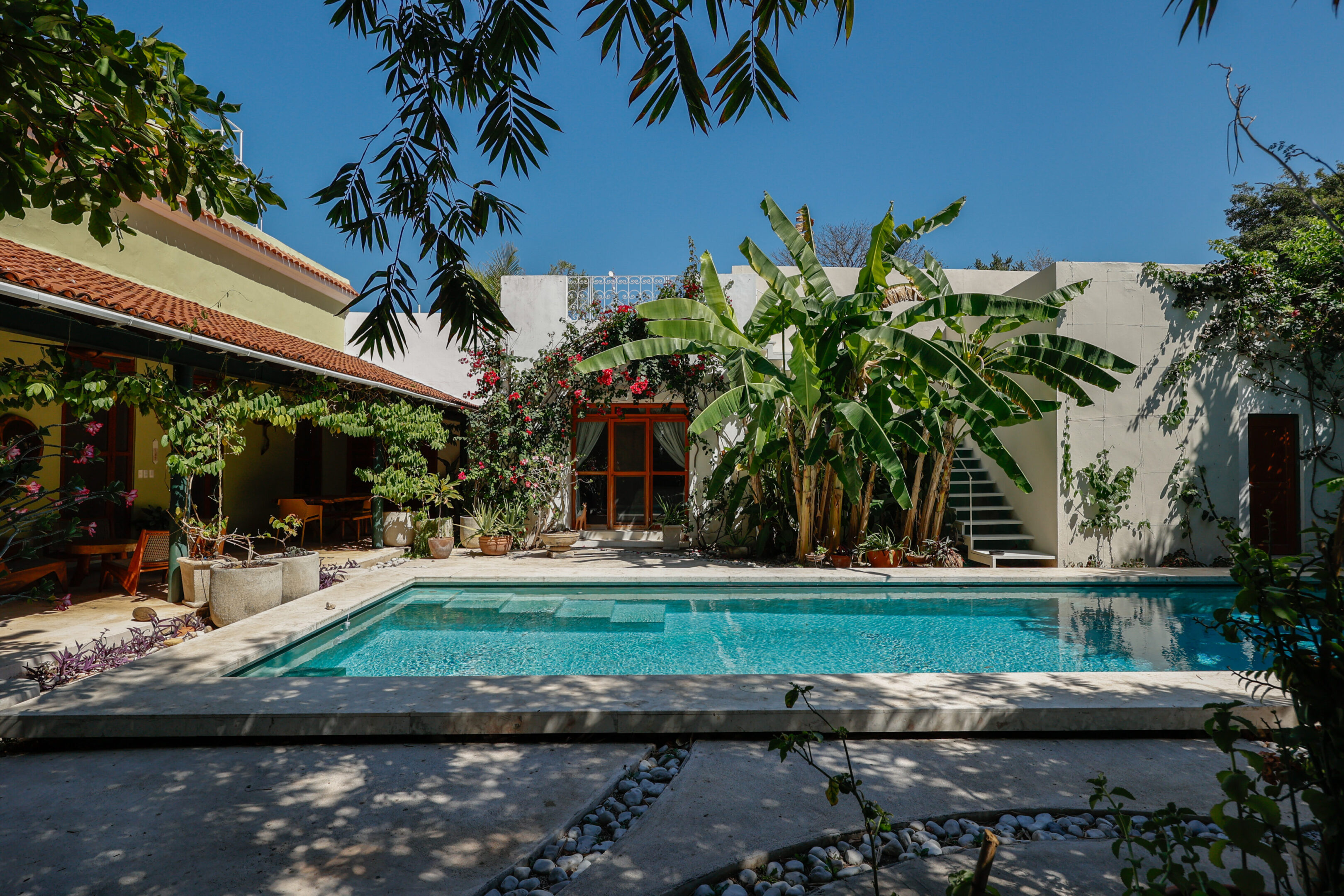 Tropical courtyard with turquoise pool.