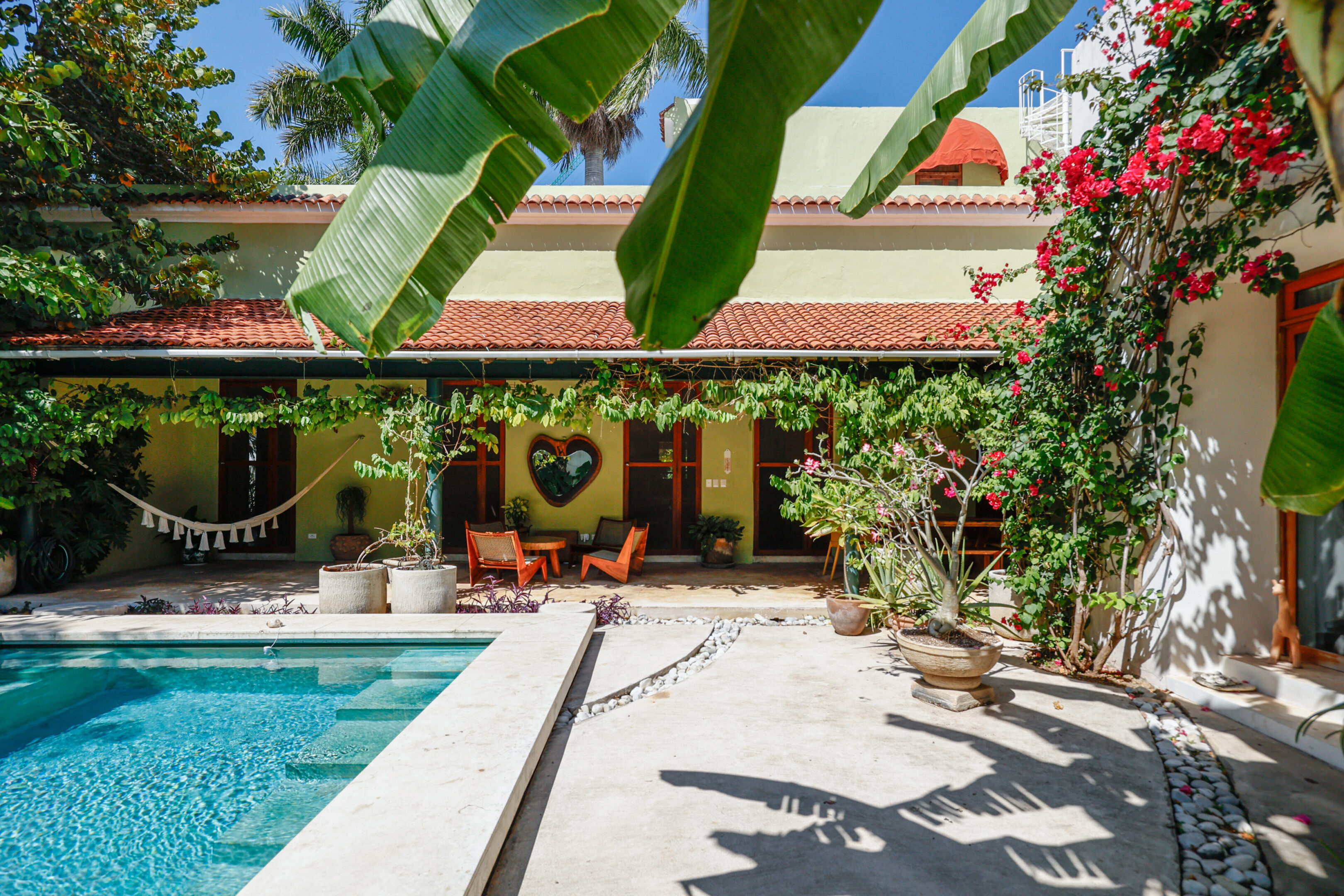 Tropical courtyard with pool and patio.