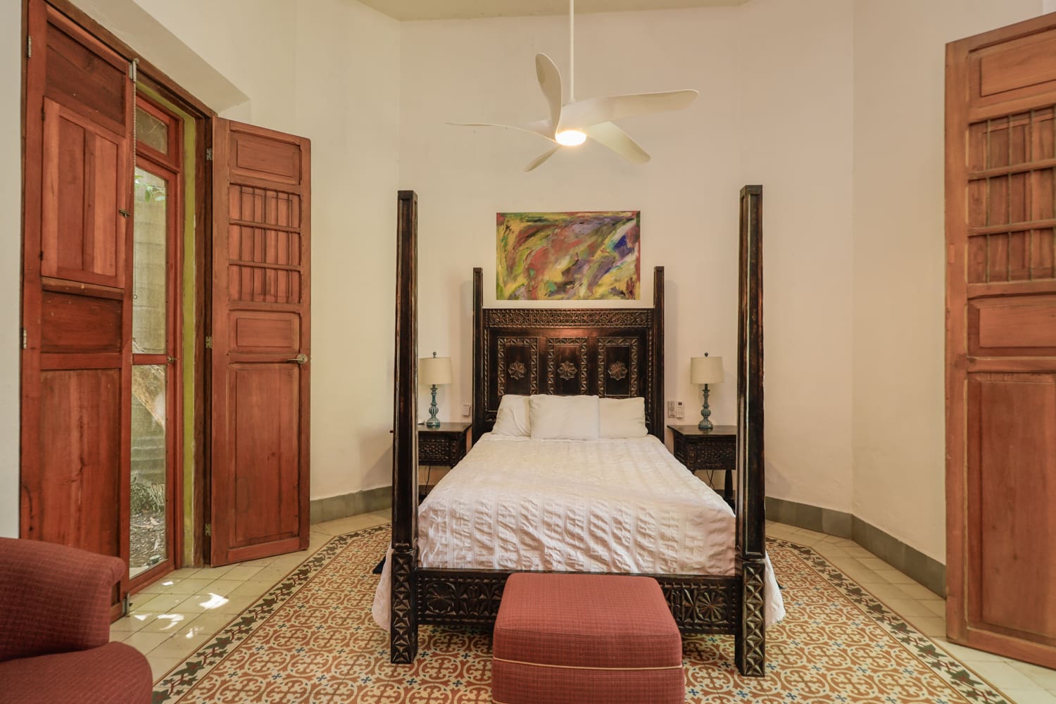 Ornate four-poster bed in a bedroom.