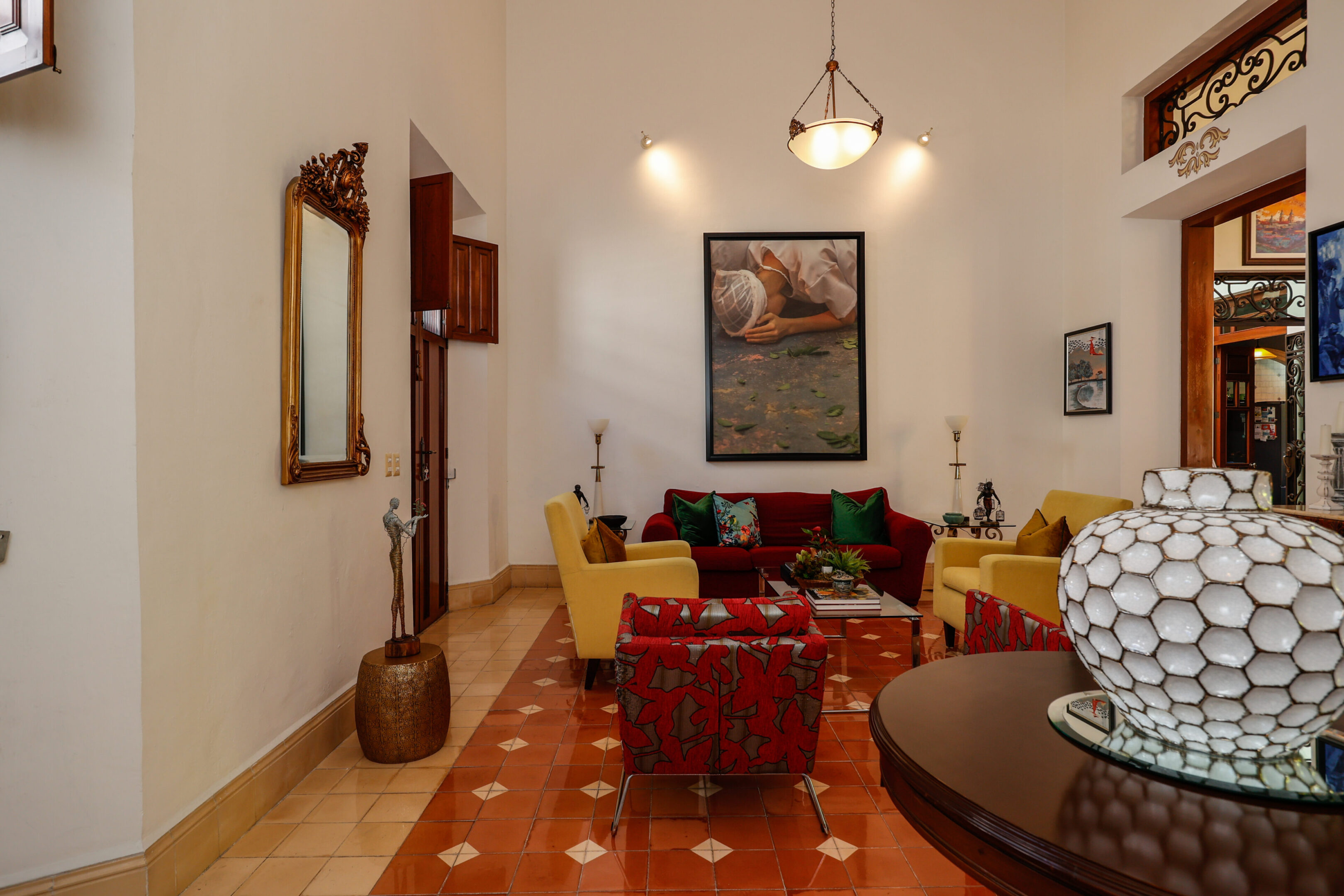 Elegant living room with red sofa and art.