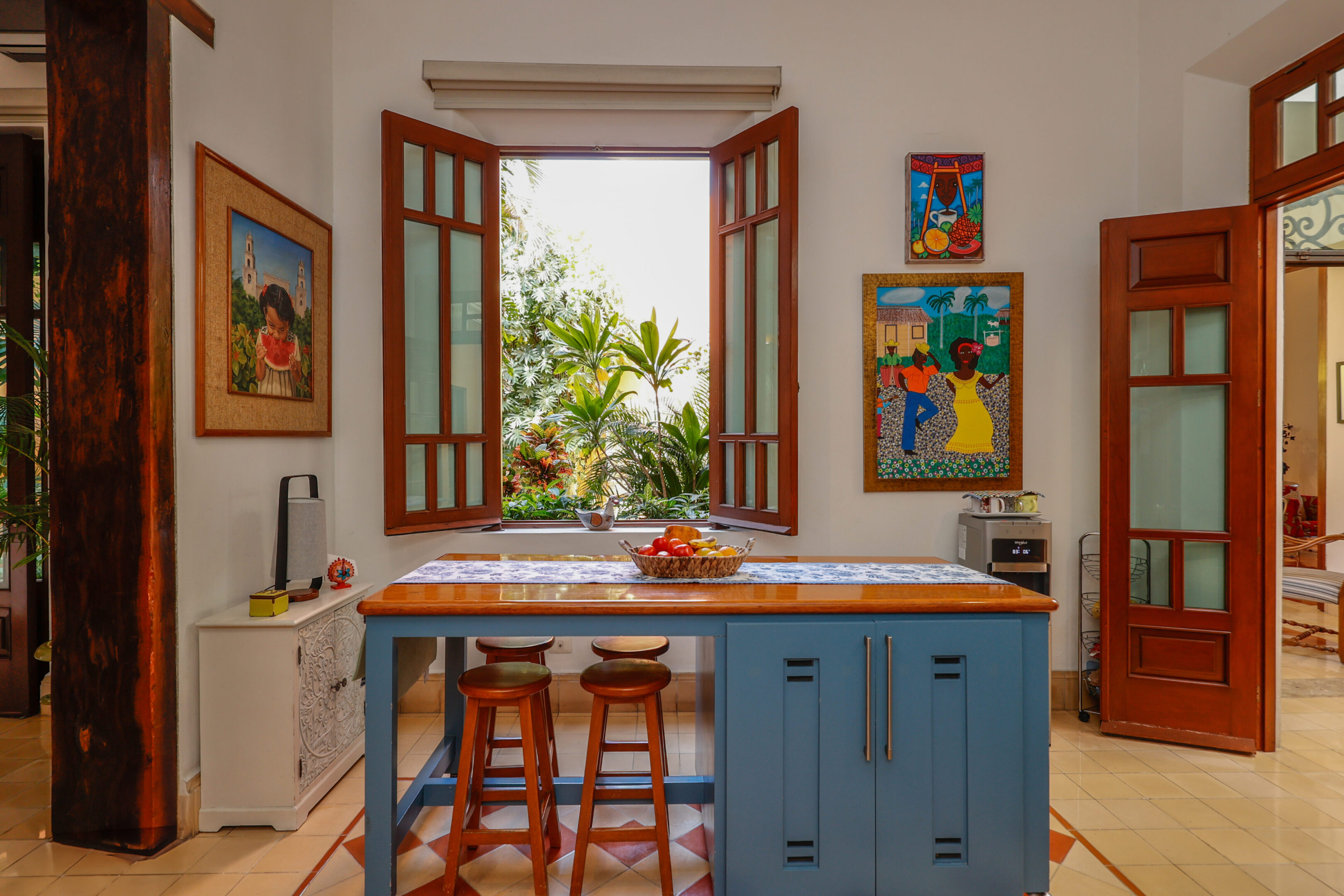 Island kitchen with tropical artwork.