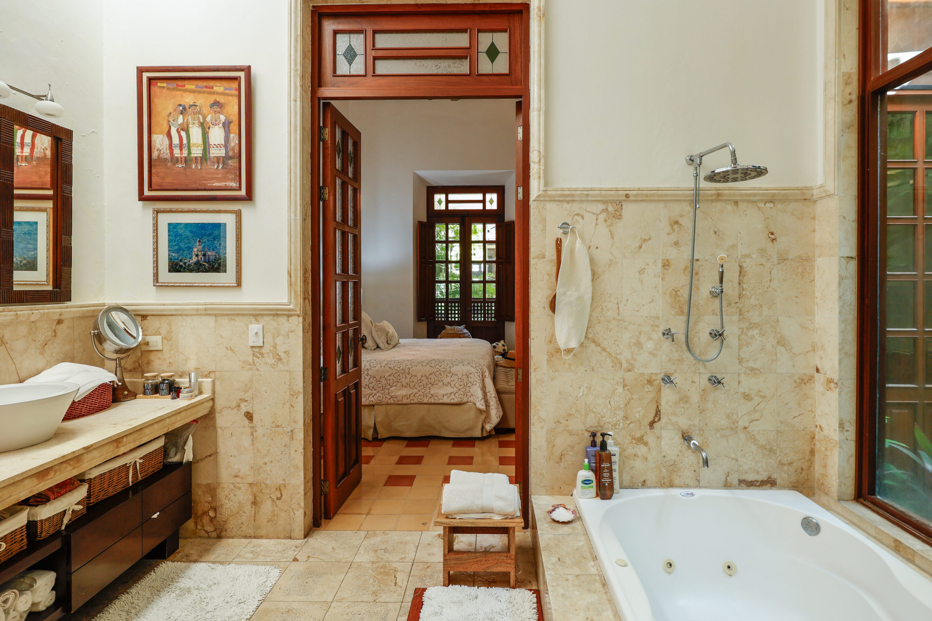 Luxurious bathroom with a view of bedroom.