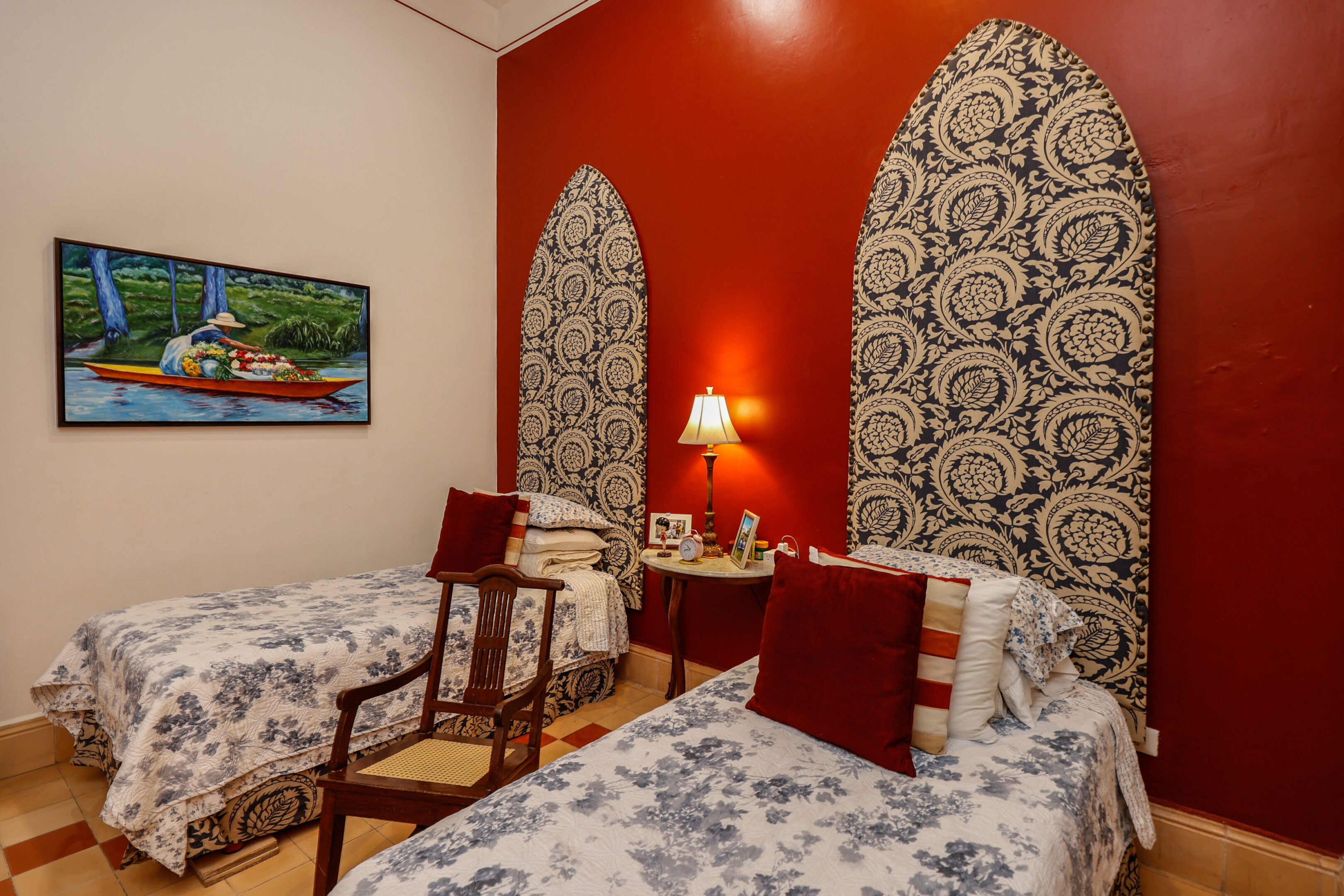 Twin beds with patterned headboards in bedroom.
