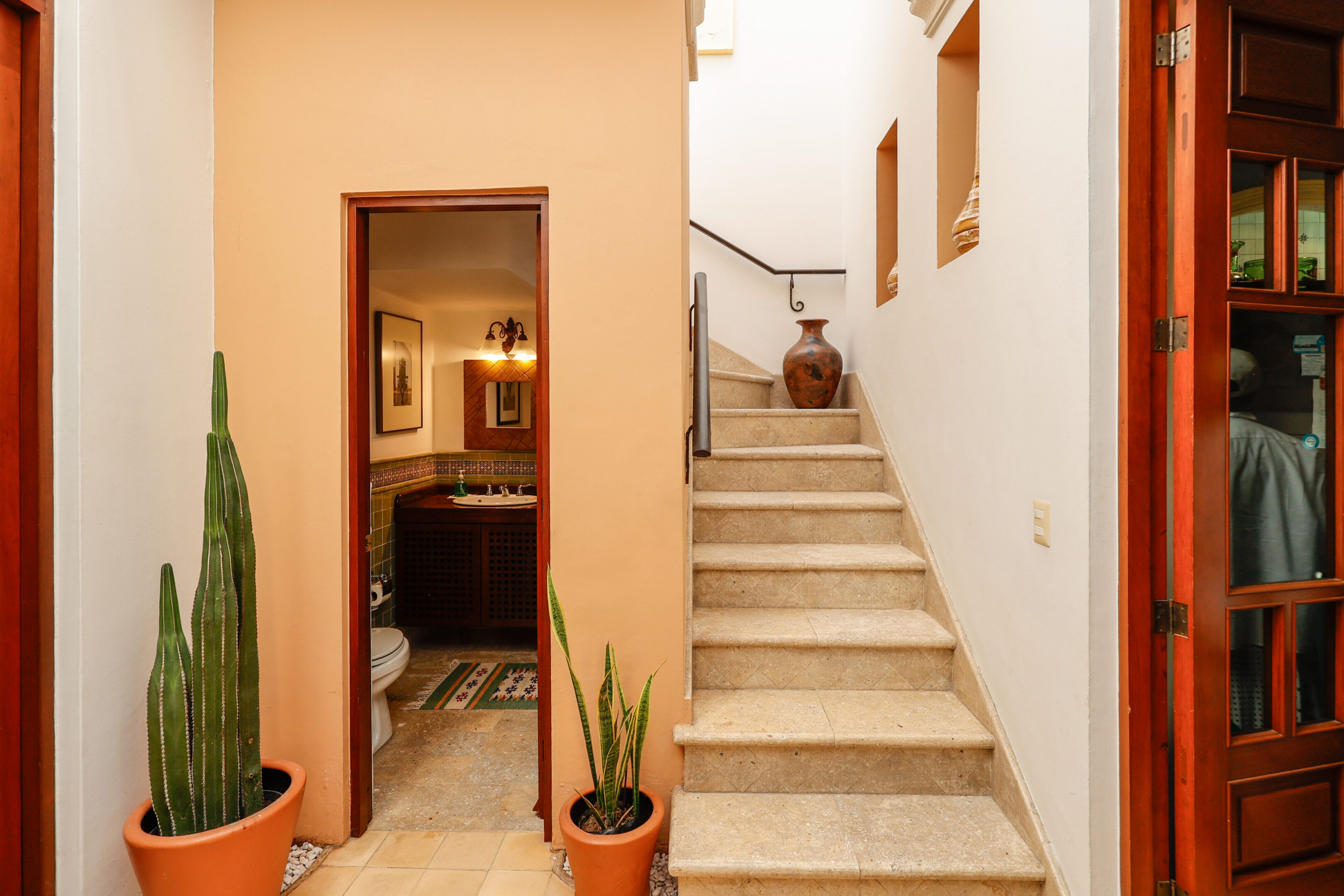 Stone staircase, cactus, and small bathroom.