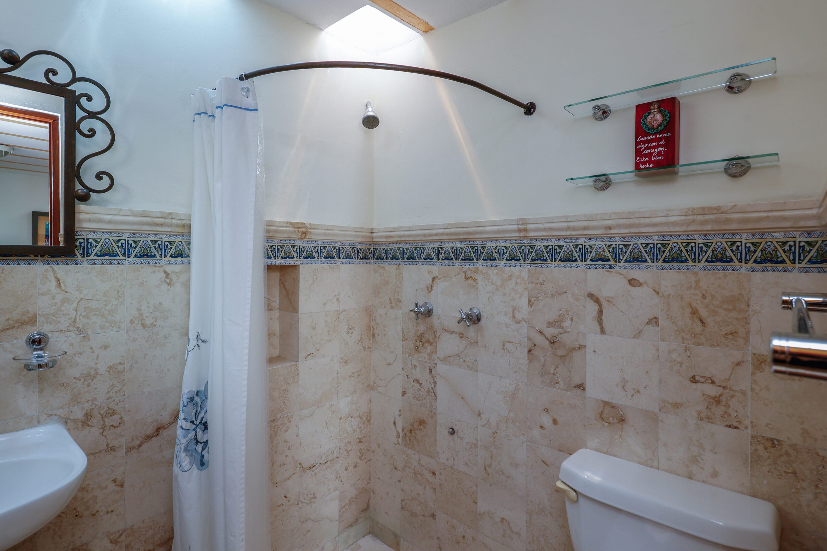Small bathroom with tiled walls.