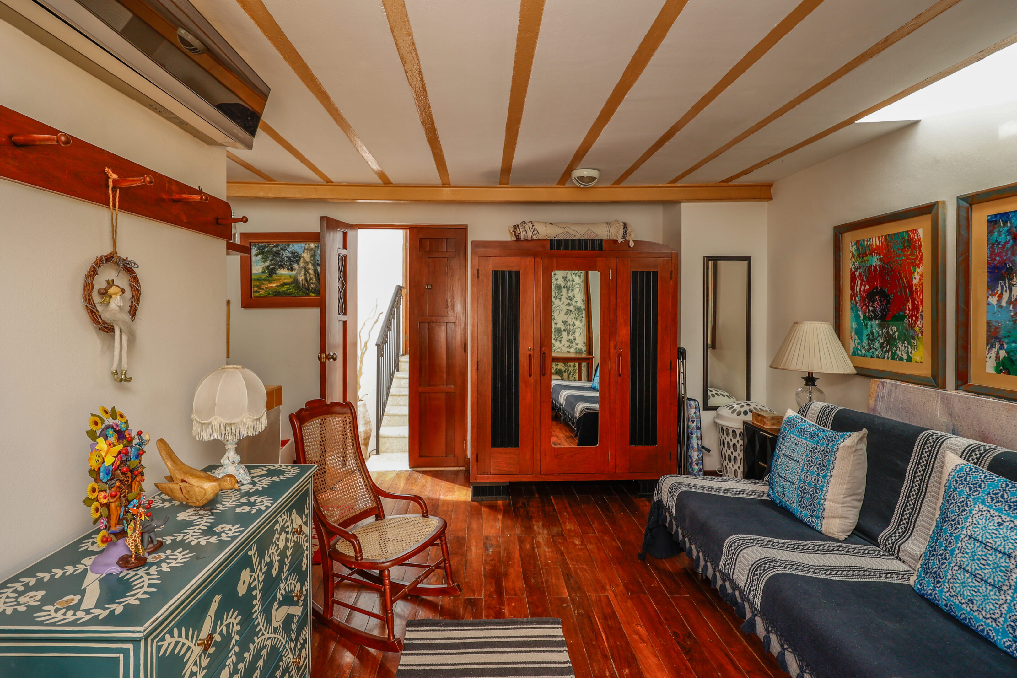 Cozy room with wooden floors and artwork.